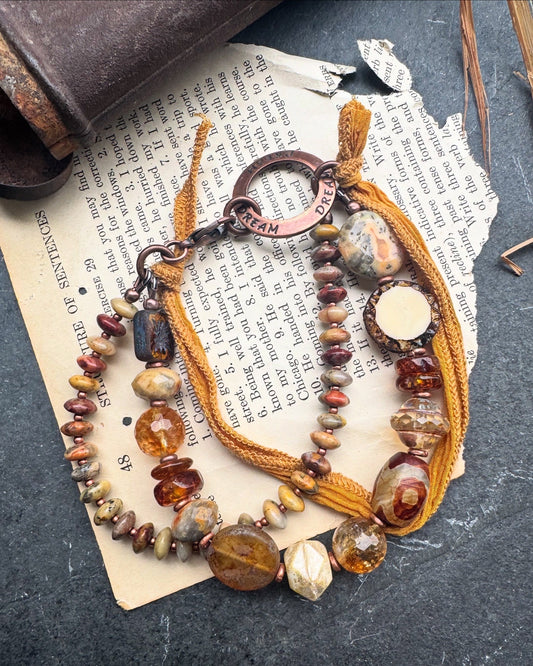 Amber, crazy lace agate, citrine, Czech glass, silk ribbon, copper, bracelet. Message ring says dream.