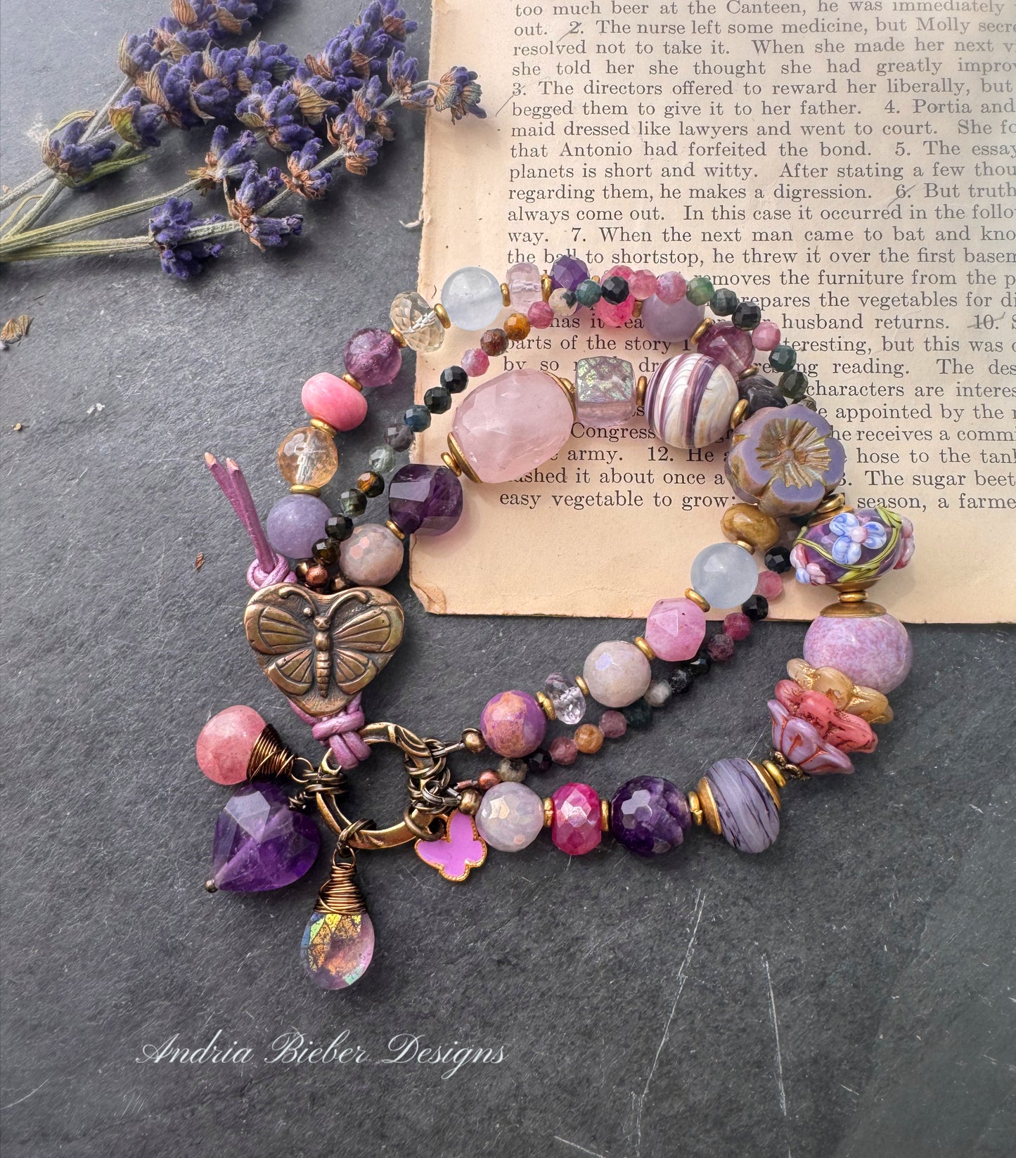 Handmade lampwork glass, mixed gemstone, ceramic, Czech Glass and butterfly button button. Purple leather closure.