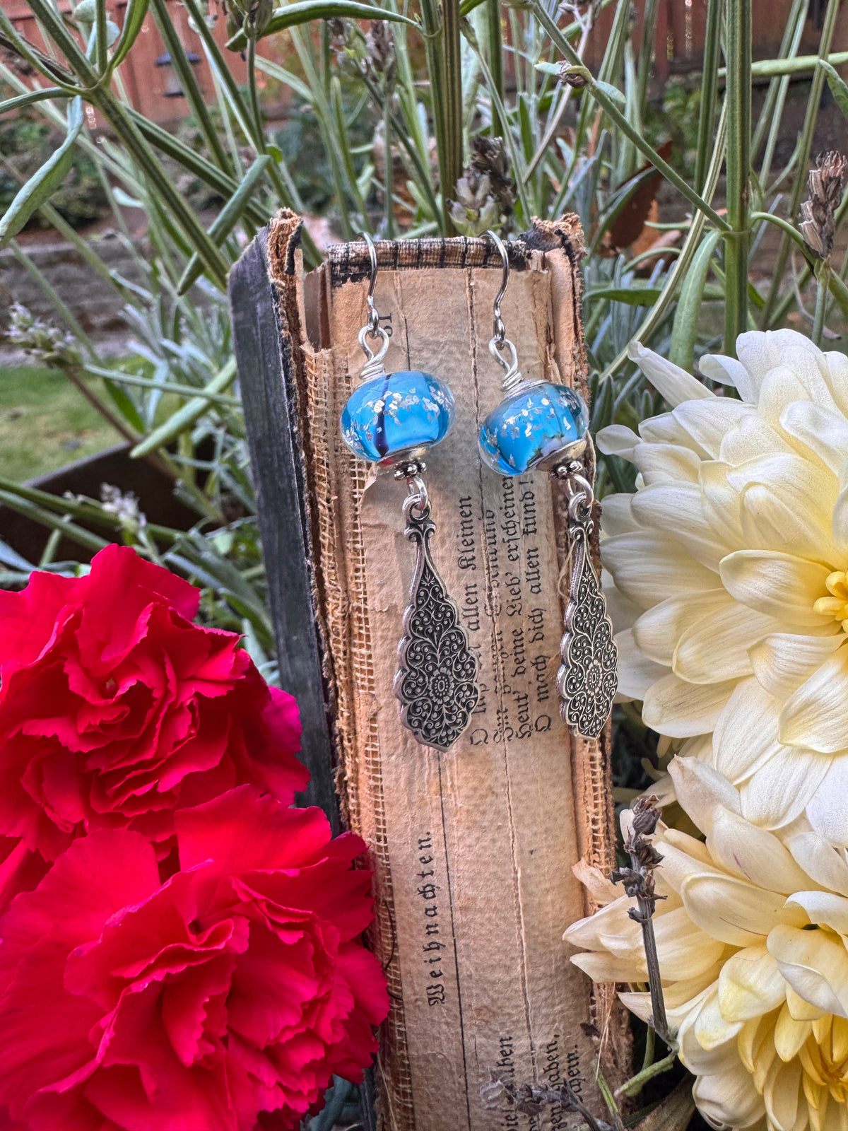 Handmade lampwork glass in blue and black, silver filigree drop, earrings.
