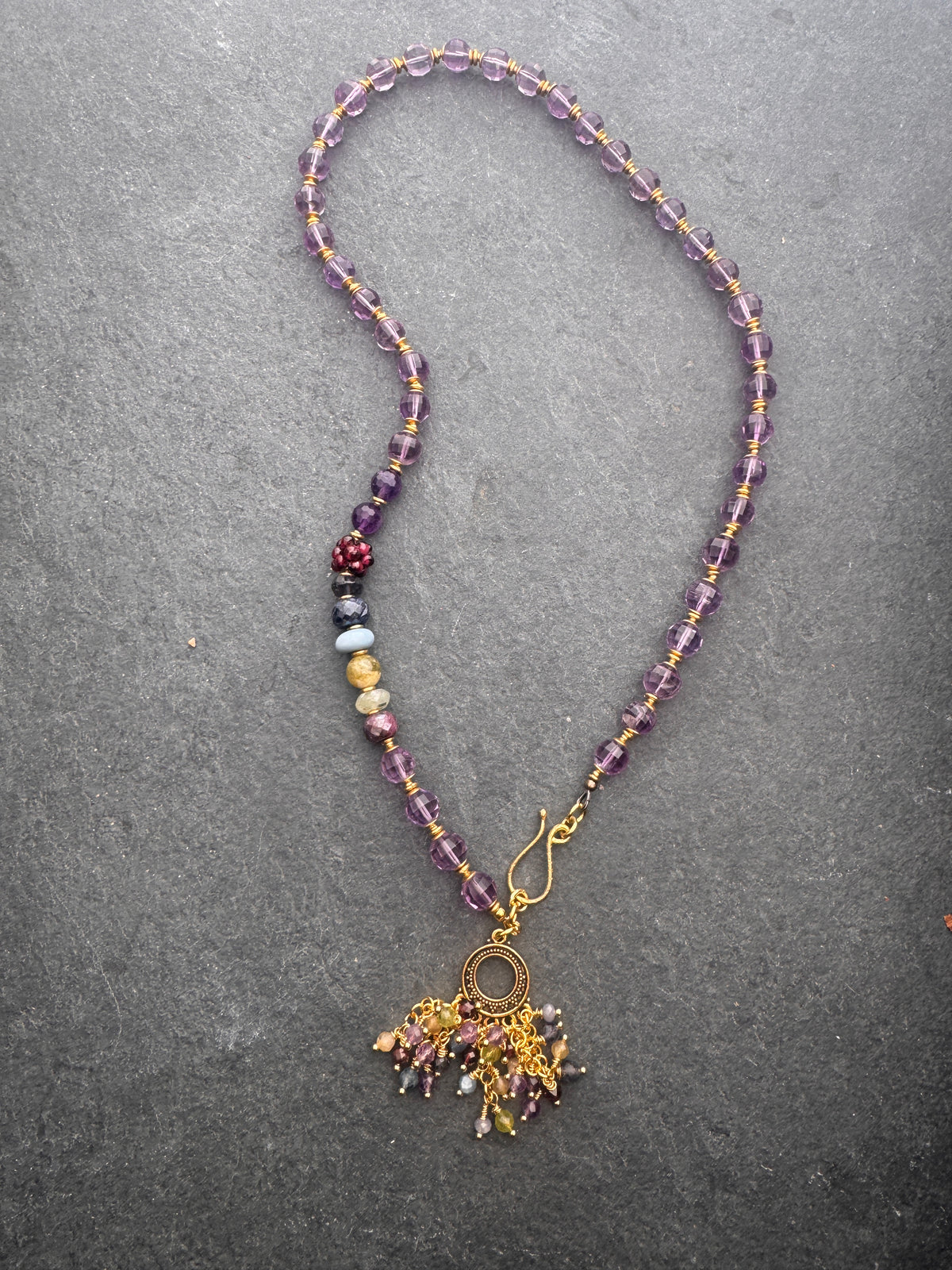 Amethyst faceted gemstone, iolite, green garnet, garnet, prehnite, peridot, aquamarine, blue opal and brass metal, necklace.