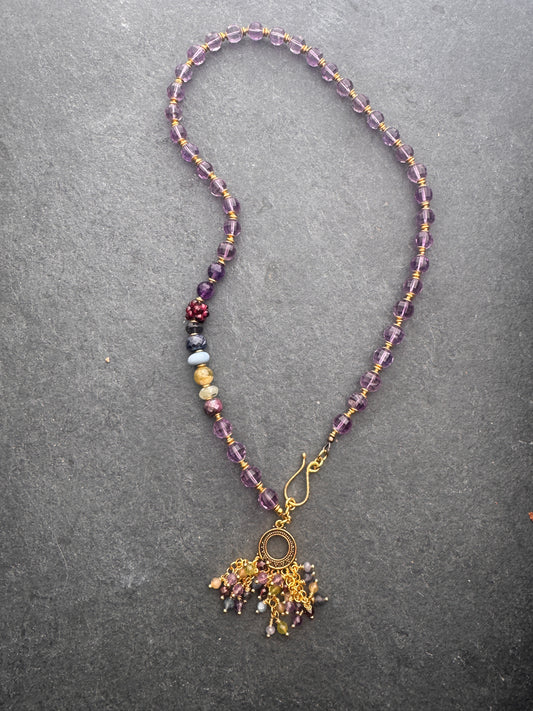 Amethyst faceted gemstone, iolite, green garnet, garnet, prehnite, peridot, aquamarine, blue opal and brass metal, necklace.
