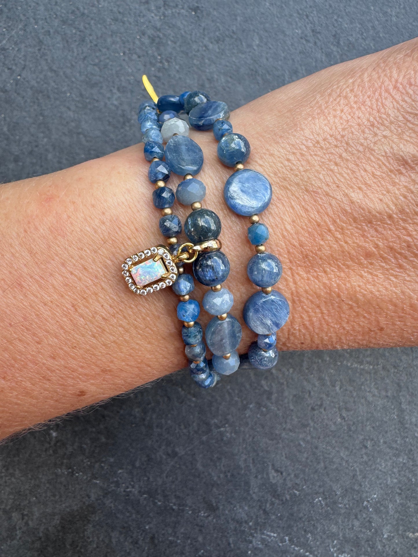 Kyanite gemstone and gold metal bracelet.