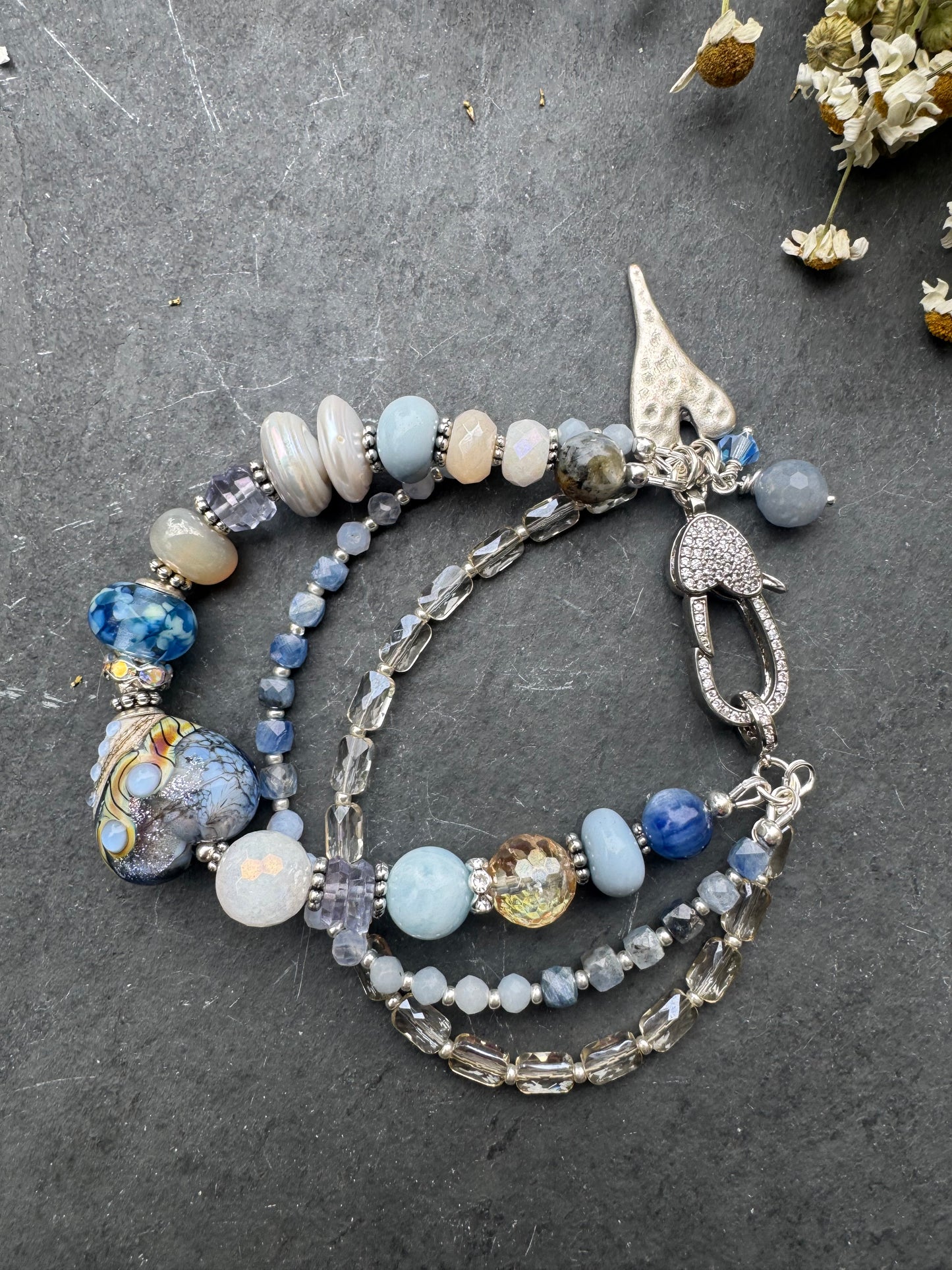 Lamp work glass, blue opal, blue kyanite, mystic moonstone, mystic citrine, pearls, iolite, aquamarine, crazy lace blue agate, blue aventurine stone, silver metal, rhinestone clasp, bracelet