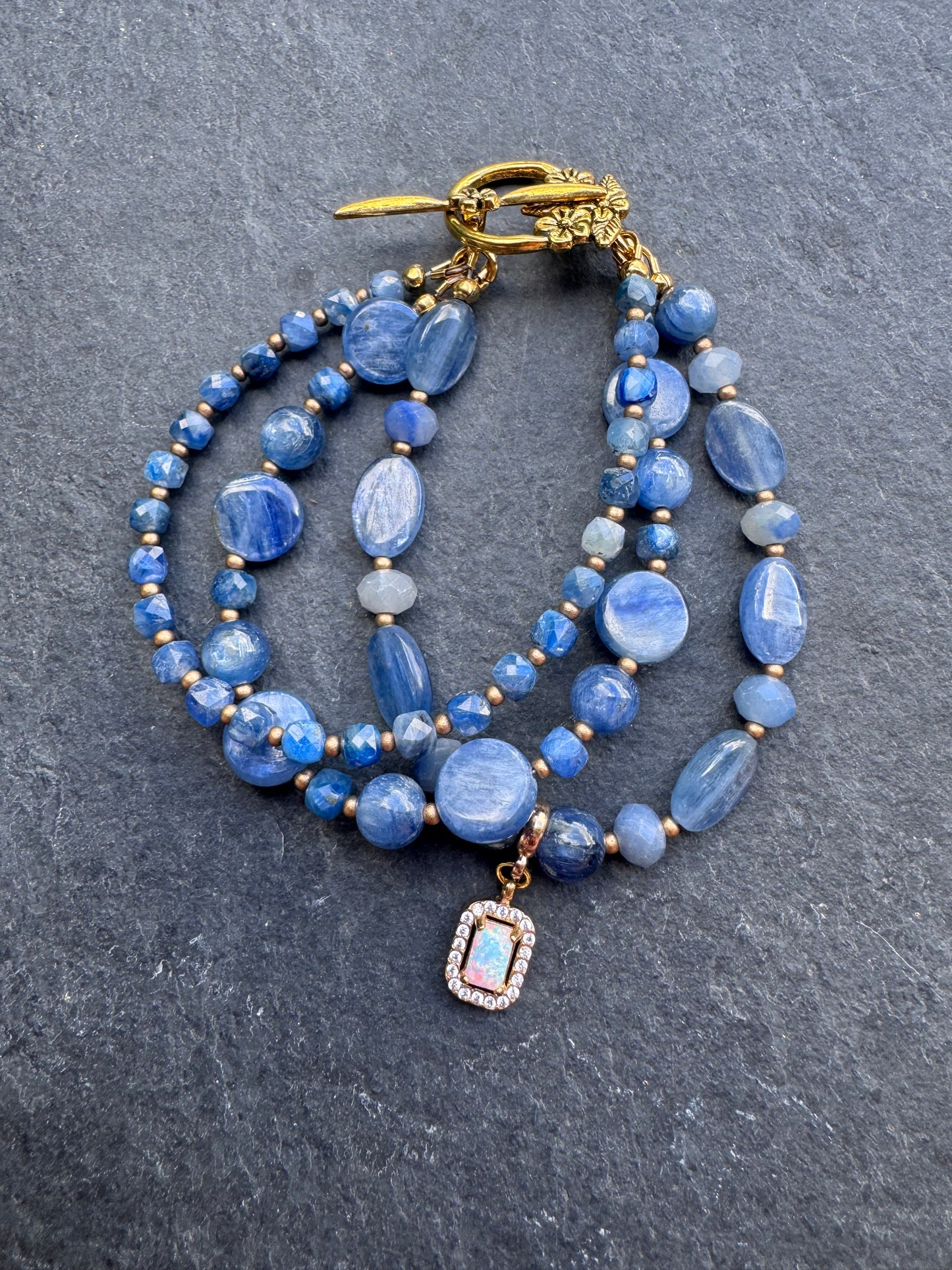 Kyanite gemstone and gold metal bracelet.