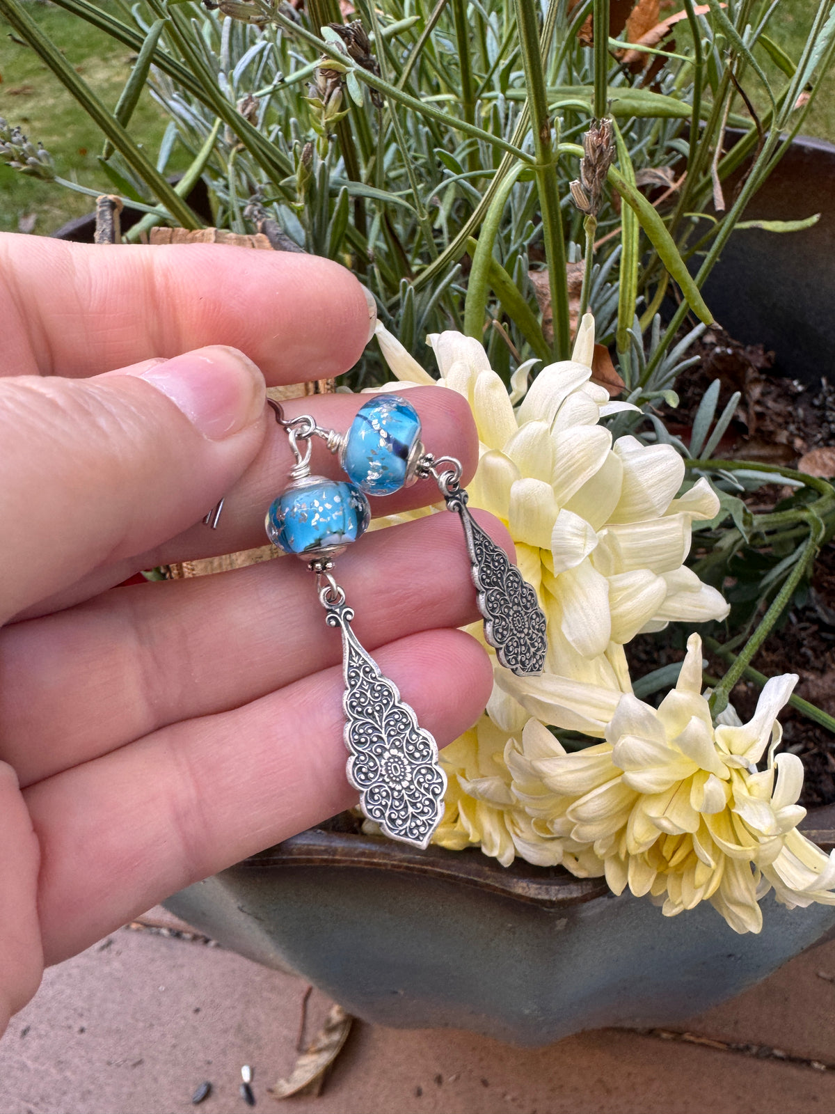 Handmade lampwork glass in blue and black, silver filigree drop, earrings.