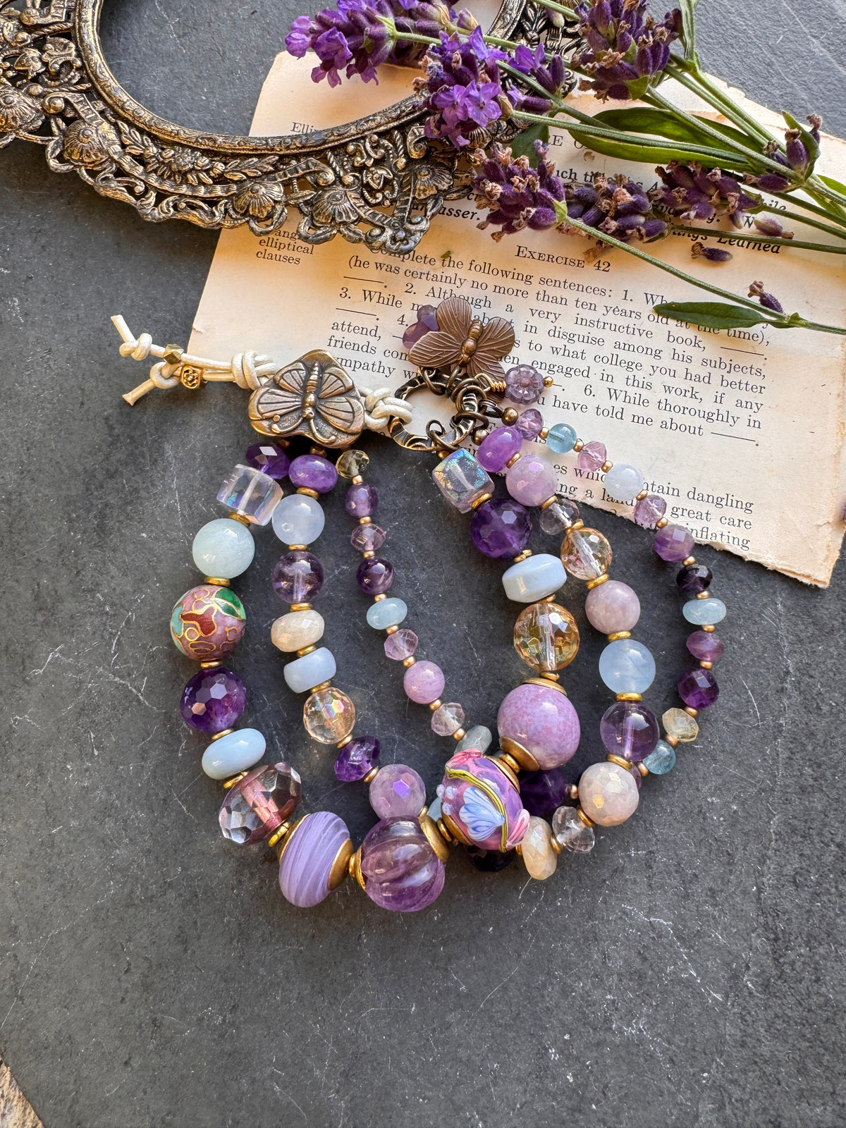 Handmade lampwork glass, 
Amethyst, citrine, aquamarine, faceted green amethyst, fluorite stone, purple oyster, and bronze  butterfly metal button.