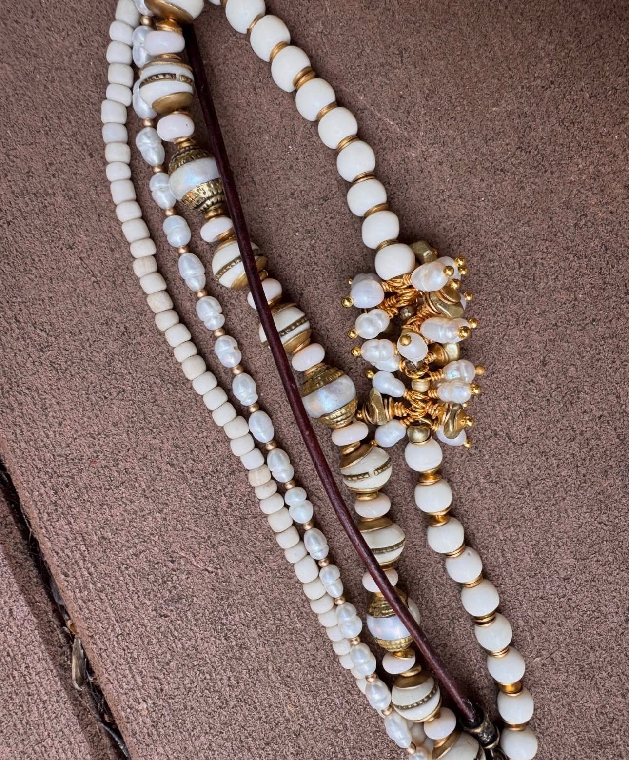 pearls, moonstone, java glass, leather, bone, African brass