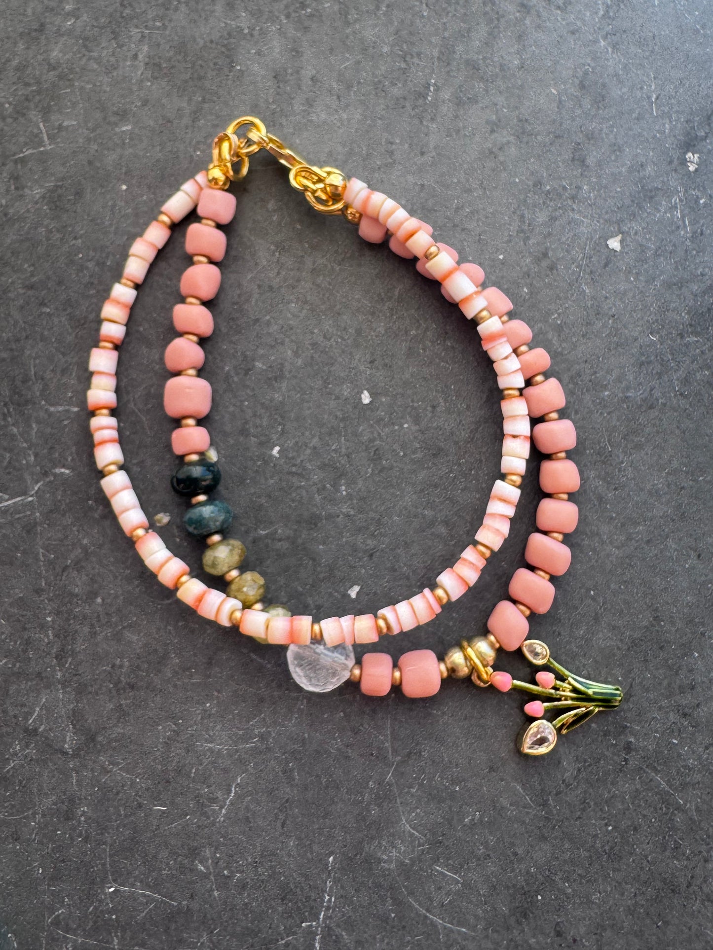 Pink shell, Java glass, quartz, peridot stone, gold metal bracelet.