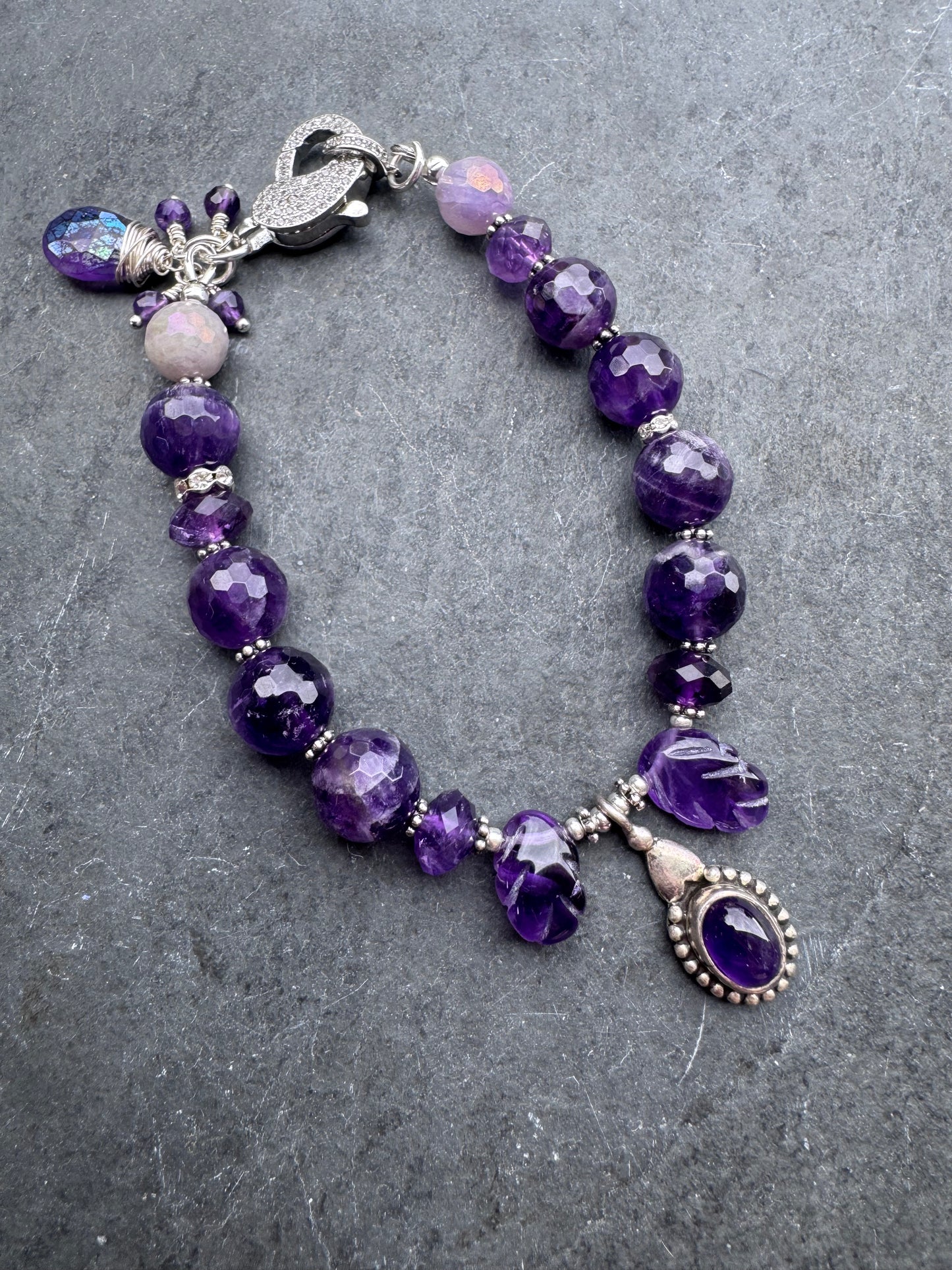 Amethyst engraved stone, faceted rounds, sterling silver drop, rhinestone clasp.925. Bracelet