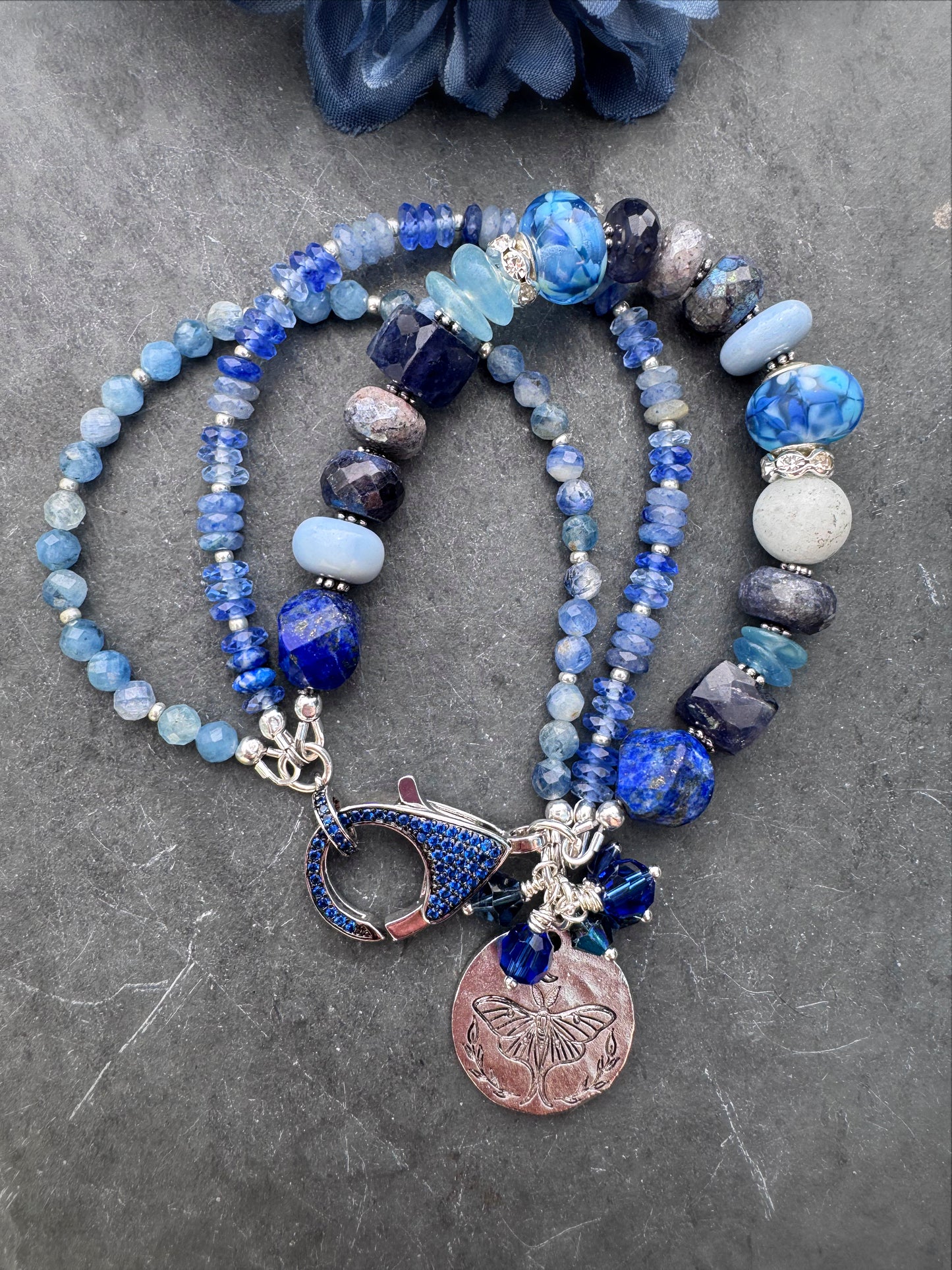 lapis lazuli, isolate, aquamarine, kyanite, Sky Blue Agate, sodalite, handmade lampwork glass, and silver metal Rhinestone clasp in deep blue crystals.