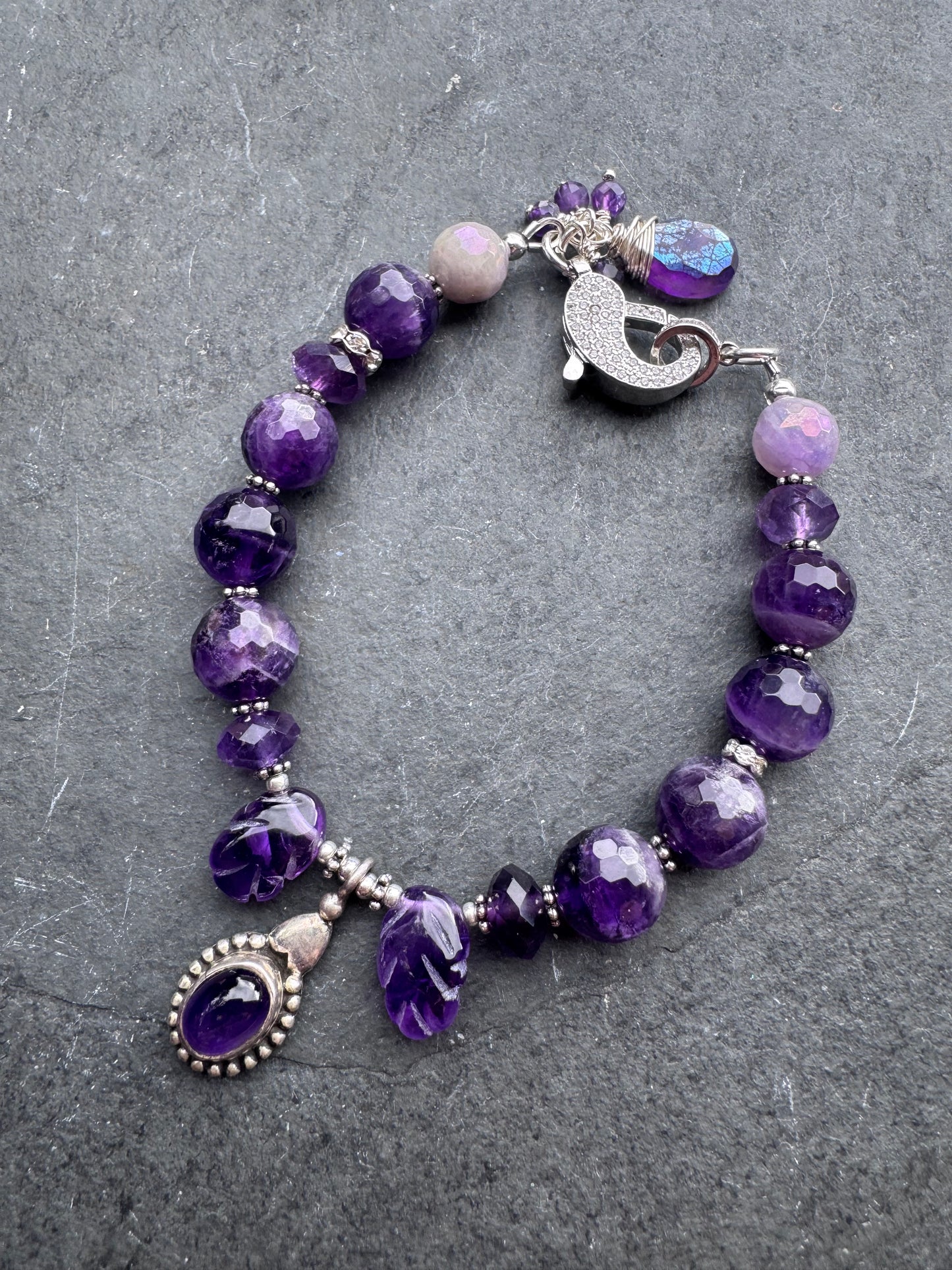 Amethyst engraved stone, faceted rounds, sterling silver drop, rhinestone clasp.925. Bracelet