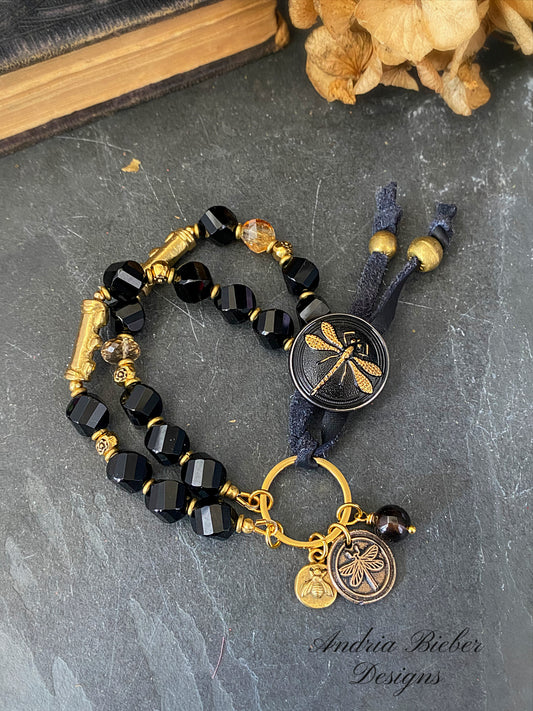 Black and gold dragonfly bracelet. With Czech glass button, onyx stone and African brass.