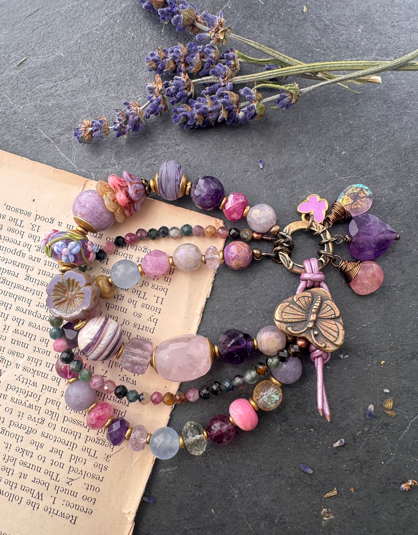 Handmade lampwork glass, mixed gemstone, ceramic, Czech Glass and butterfly button button. Purple leather closure.