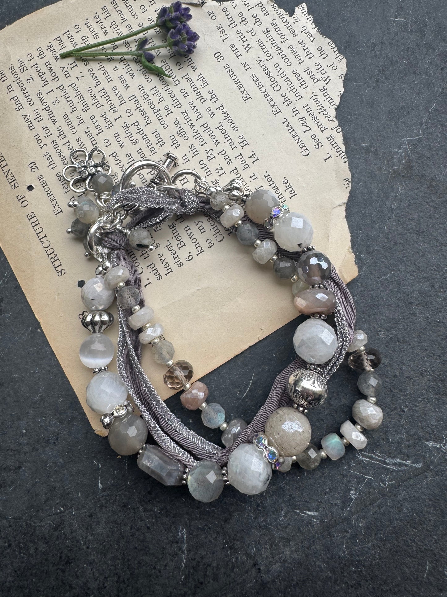 White & grey  moonstone, silver silk ribbon, and sterling silver metal.
