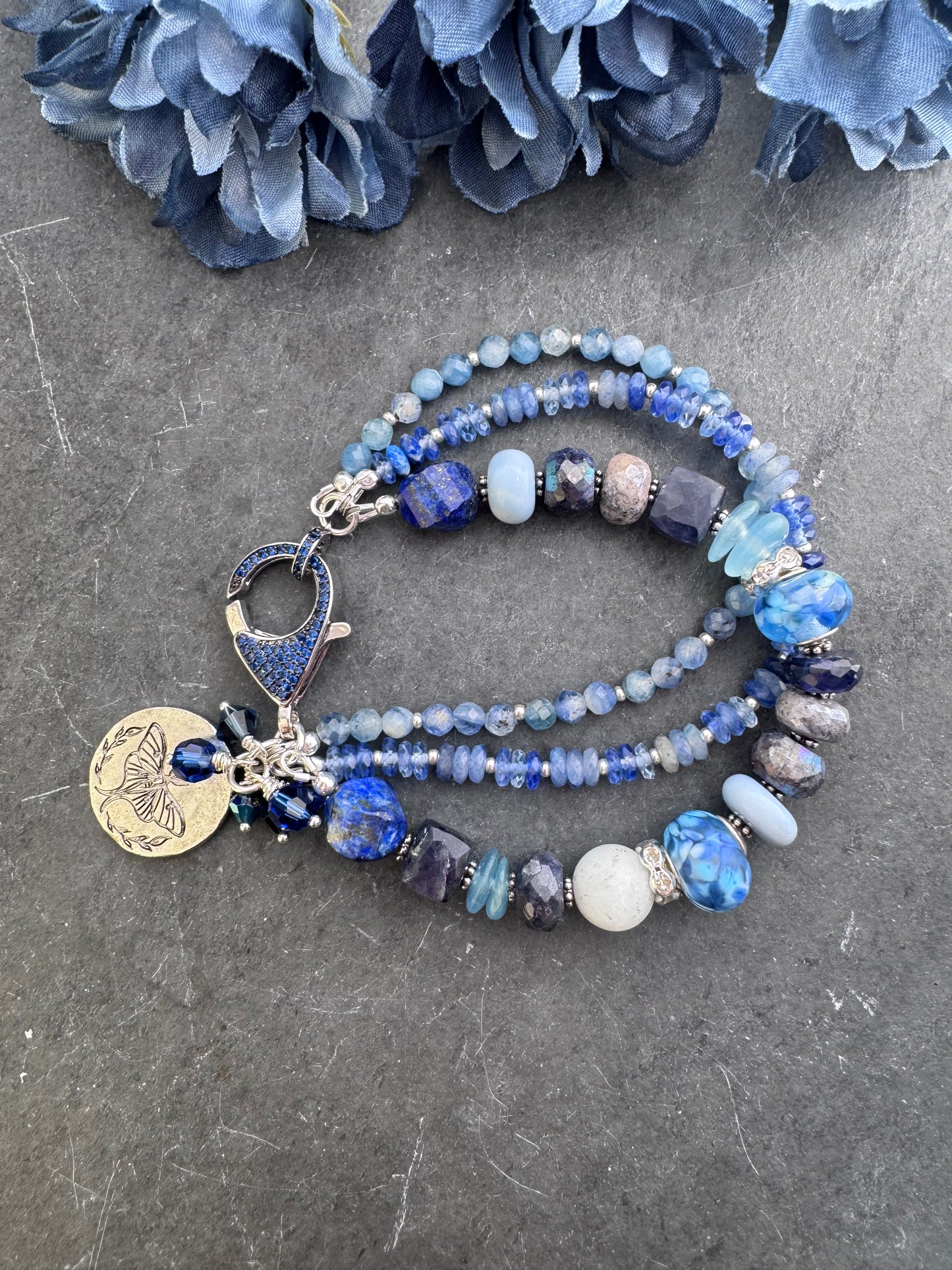 lapis lazuli, isolate, aquamarine, kyanite, Sky Blue Agate, sodalite, handmade lampwork glass, and silver metal Rhinestone clasp in deep blue crystals.