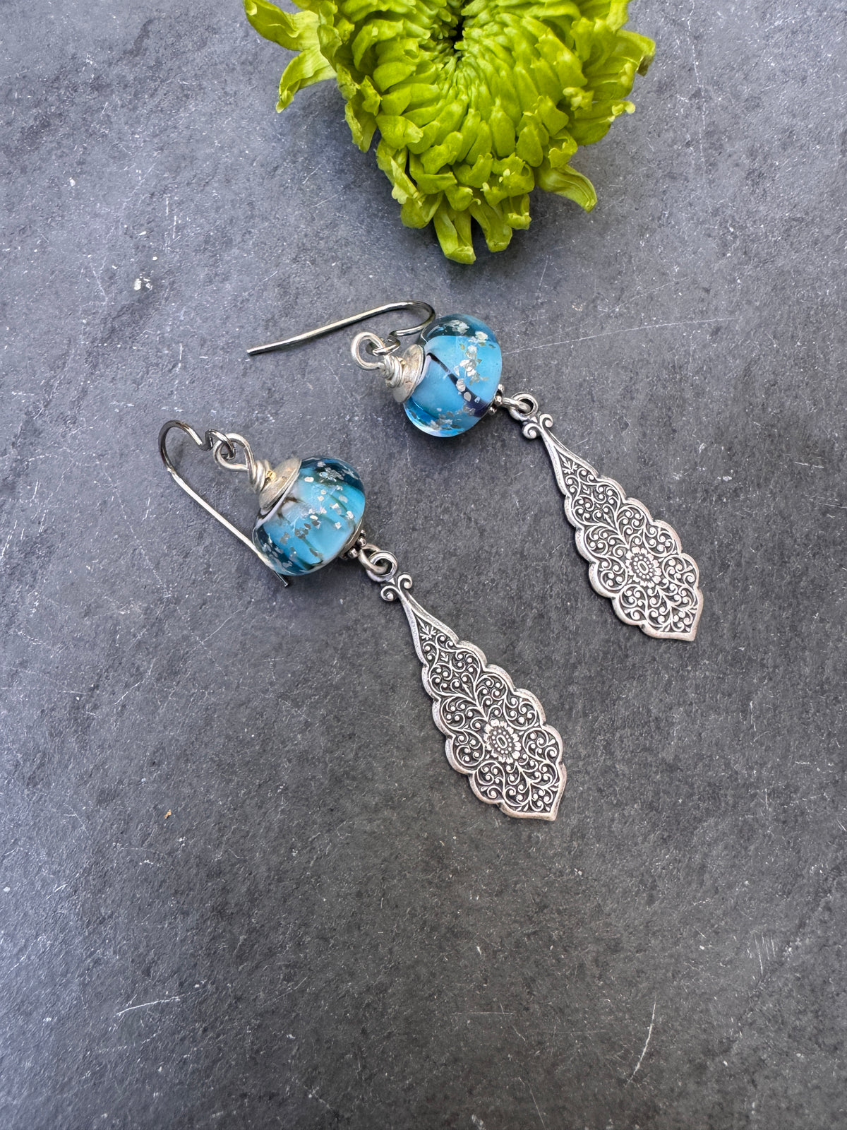 Handmade lampwork glass in blue and black, silver filigree drop, earrings.