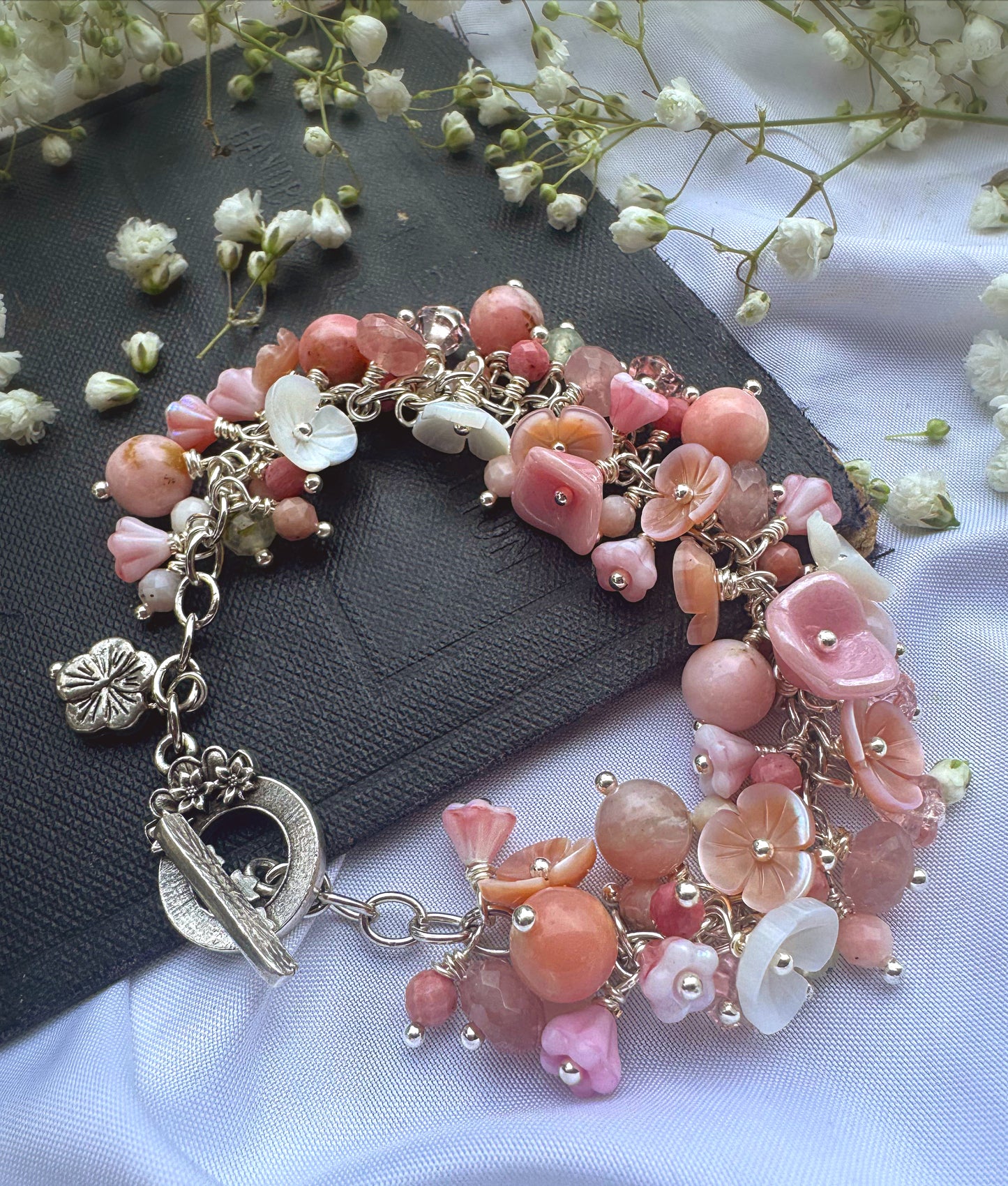 Pink opal, pink shell blossoms, rose quartz, peridot, sterling silver metal, blossom clasp, bracelet.