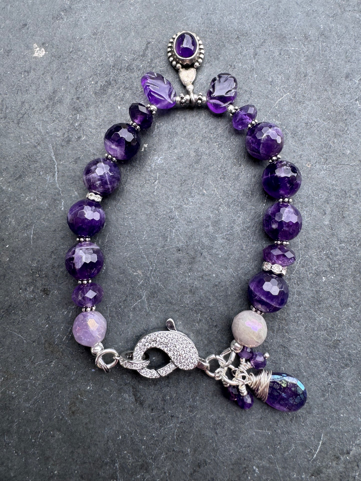 Amethyst engraved stone, faceted rounds, sterling silver drop, rhinestone clasp.925. Bracelet