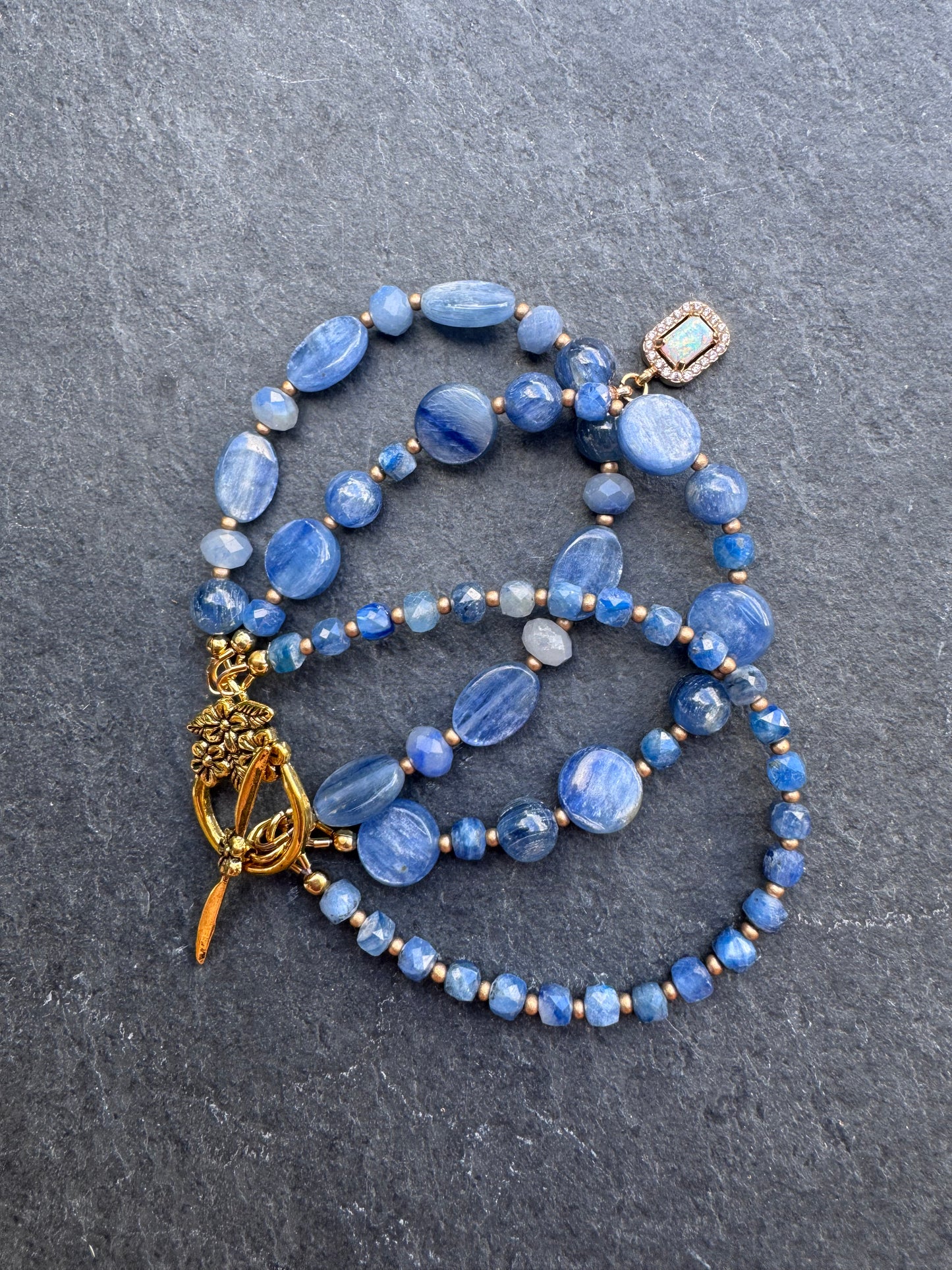 Kyanite gemstone and gold metal bracelet.