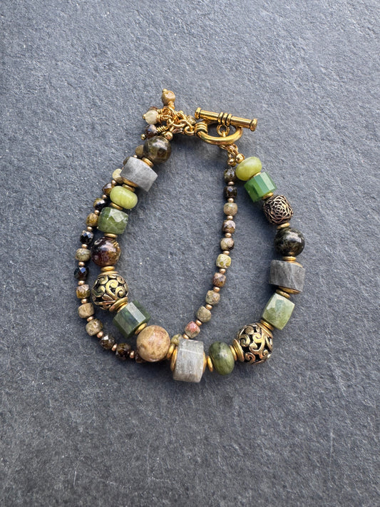 Green garnet, labradorite, jade, and gold metal bracelet.