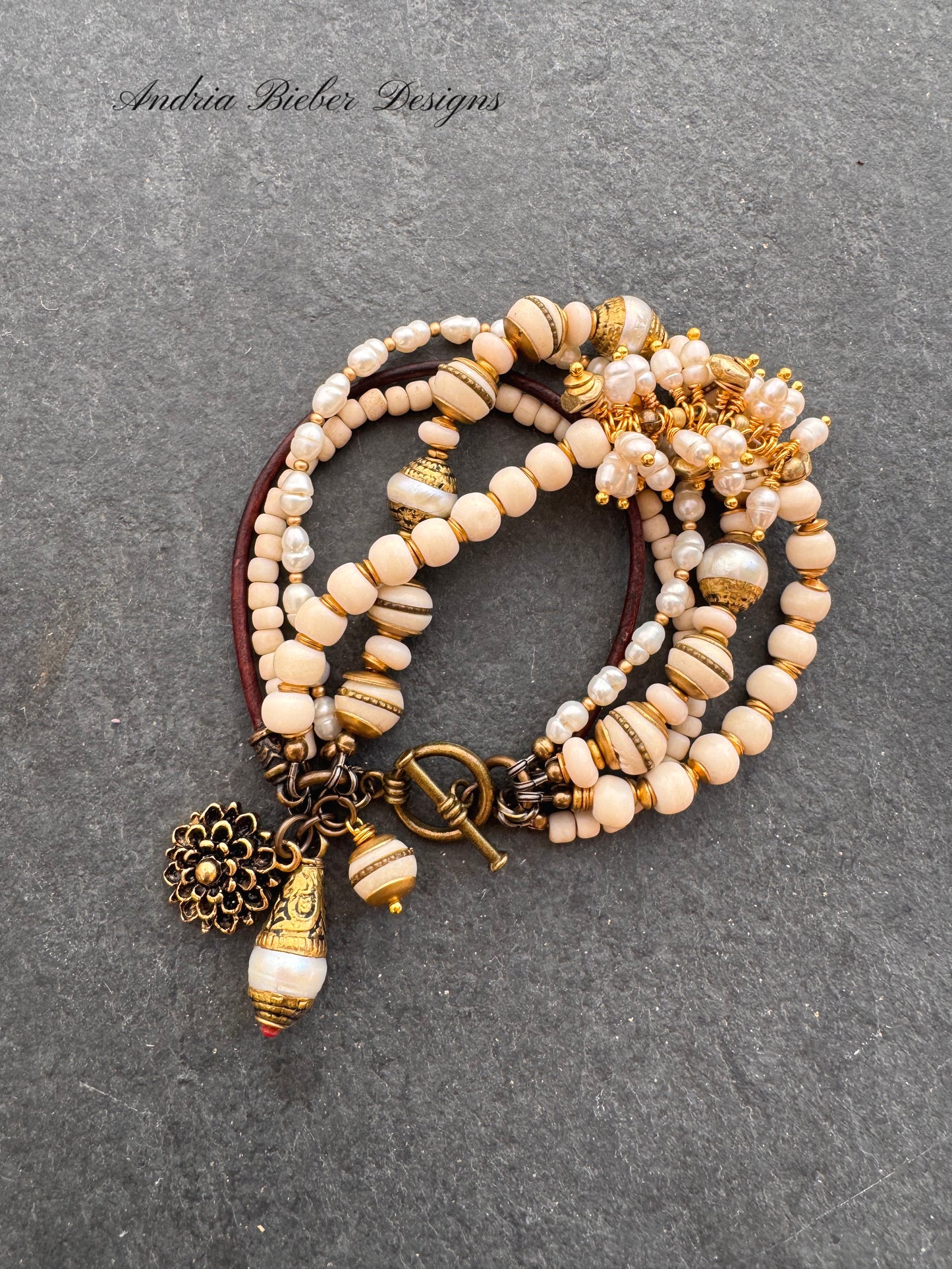 Pearls, leather, glass, brass metal bracelet.