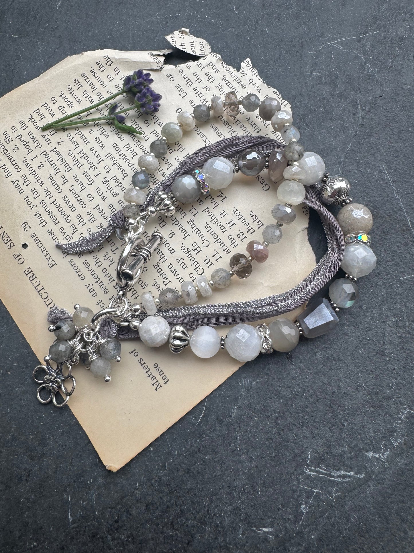 White & grey  moonstone, silver silk ribbon, and sterling silver metal.
