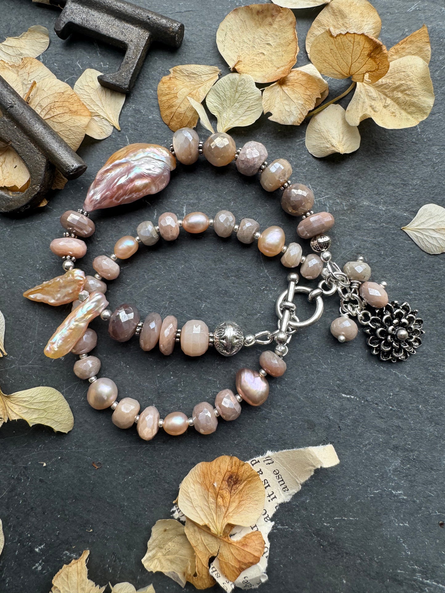 Peach moonstone, petal pink pearls, sterling and silver metal.