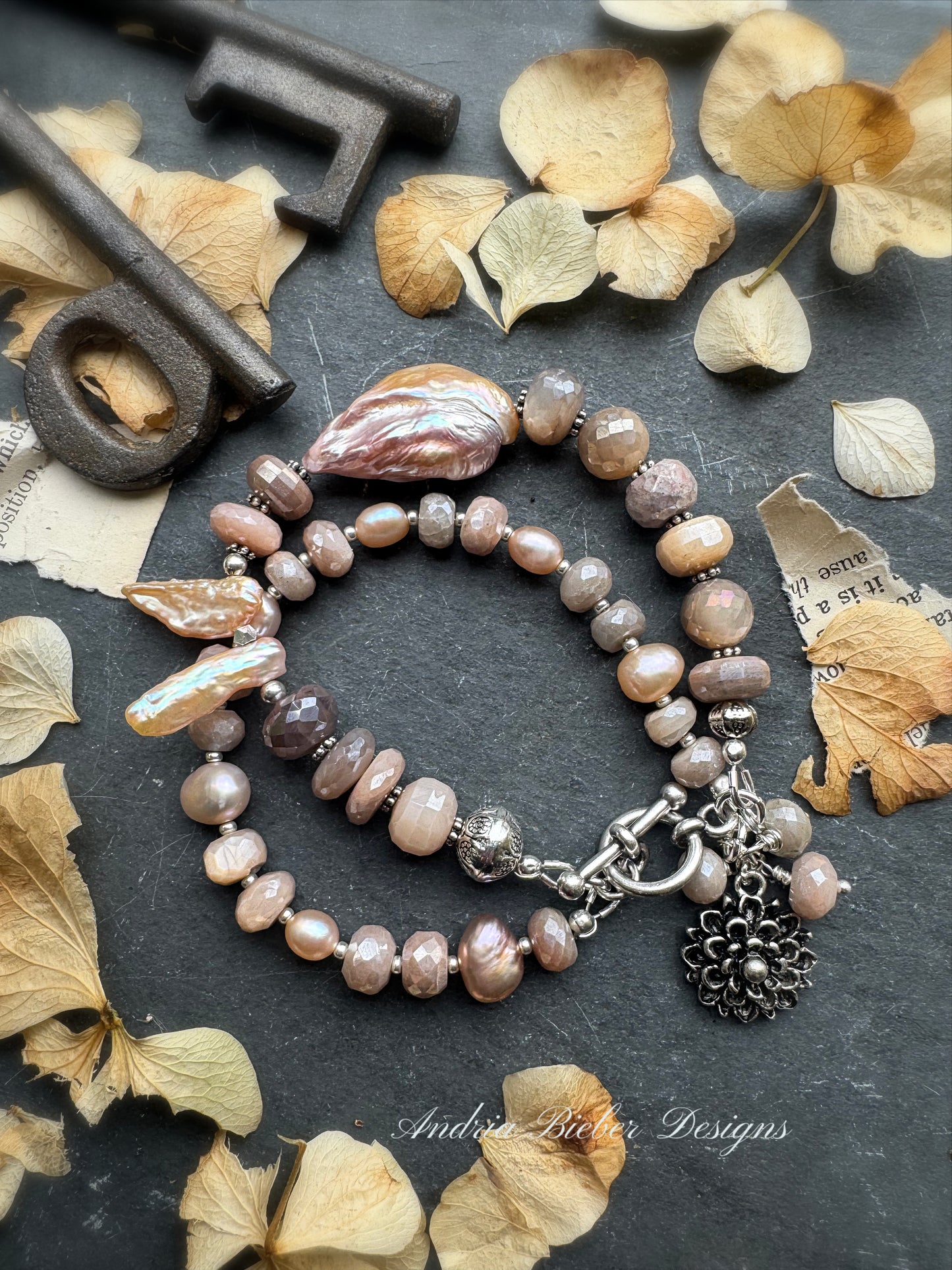 Peach moonstone, petal pink pearls, sterling and silver metal.