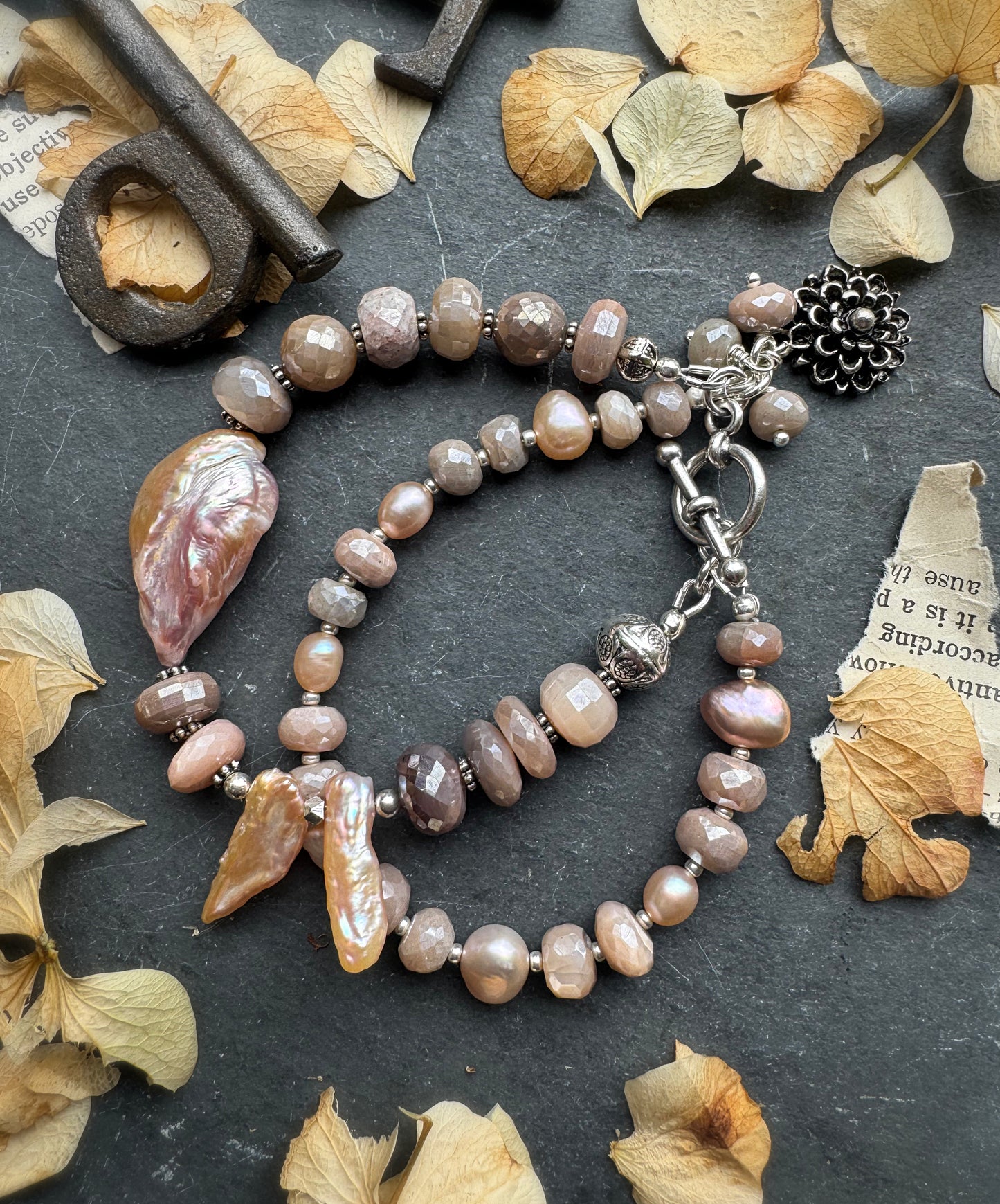 Peach moonstone, petal pink pearls, sterling and silver metal.