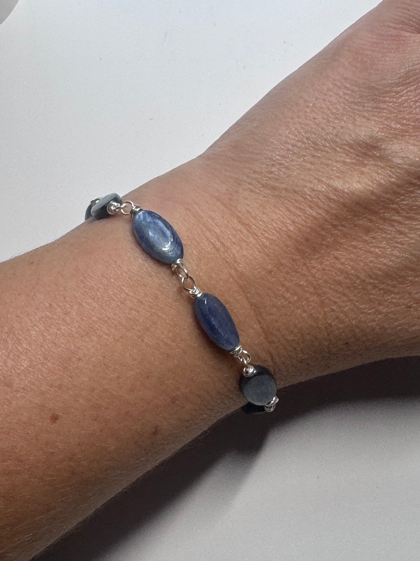 Kyanite gemstone and sterling silver metal bracelet.
