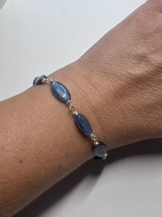 Kyanite gemstone and sterling silver metal bracelet.