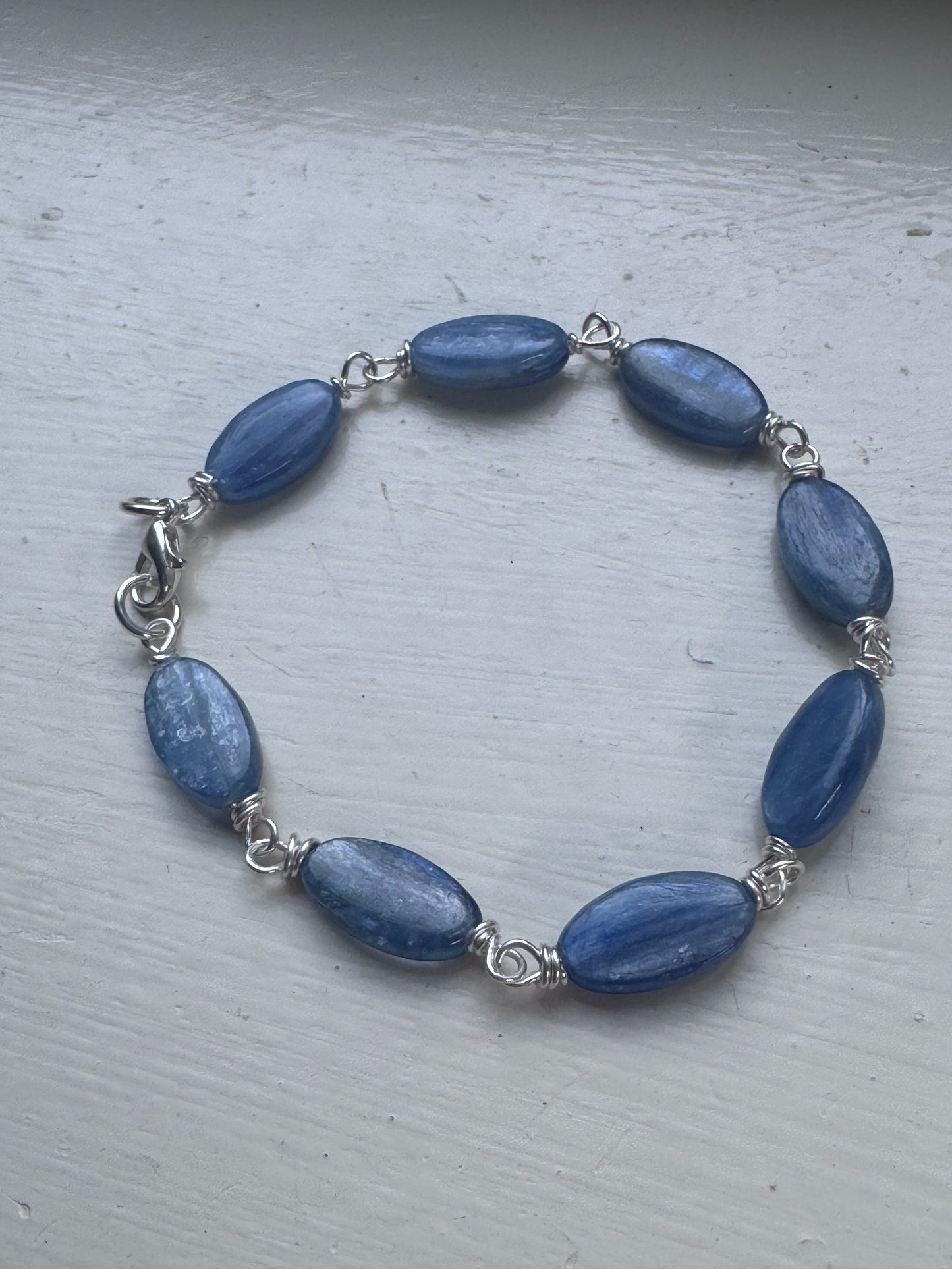 Kyanite gemstone and sterling silver metal bracelet.