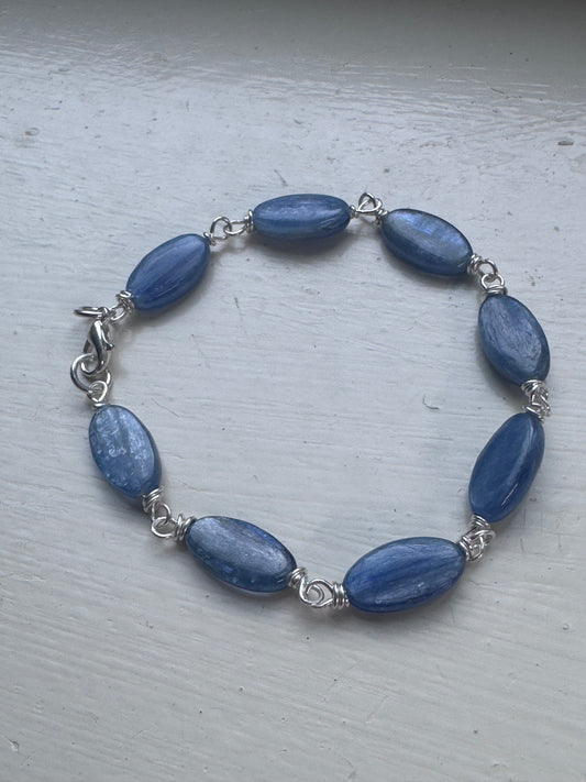 Kyanite gemstone and sterling silver metal bracelet.