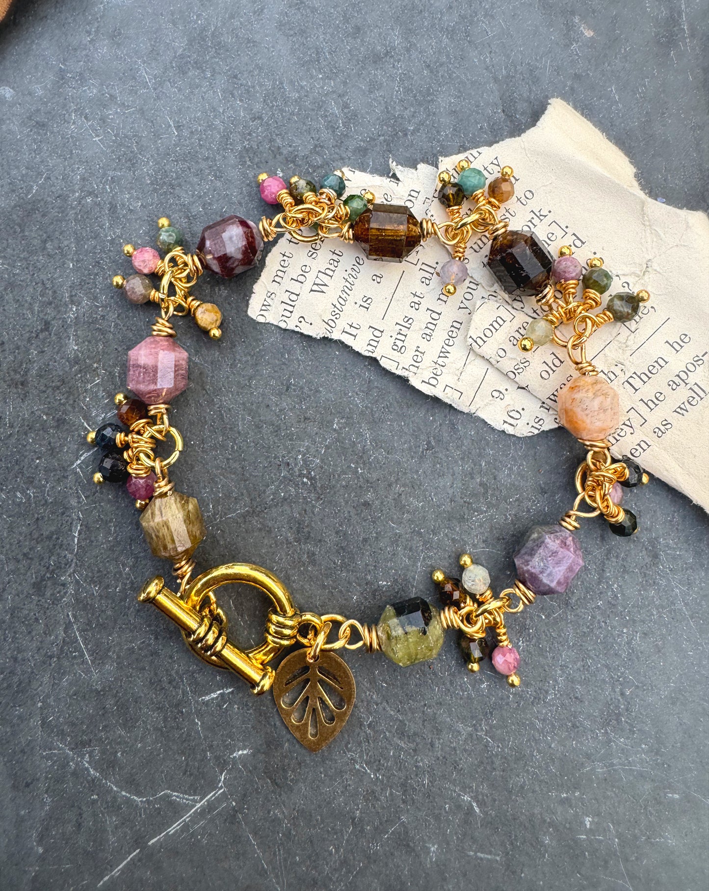 Watermelon tourmaline stone, wire wrapped, gold metal bracelet.
