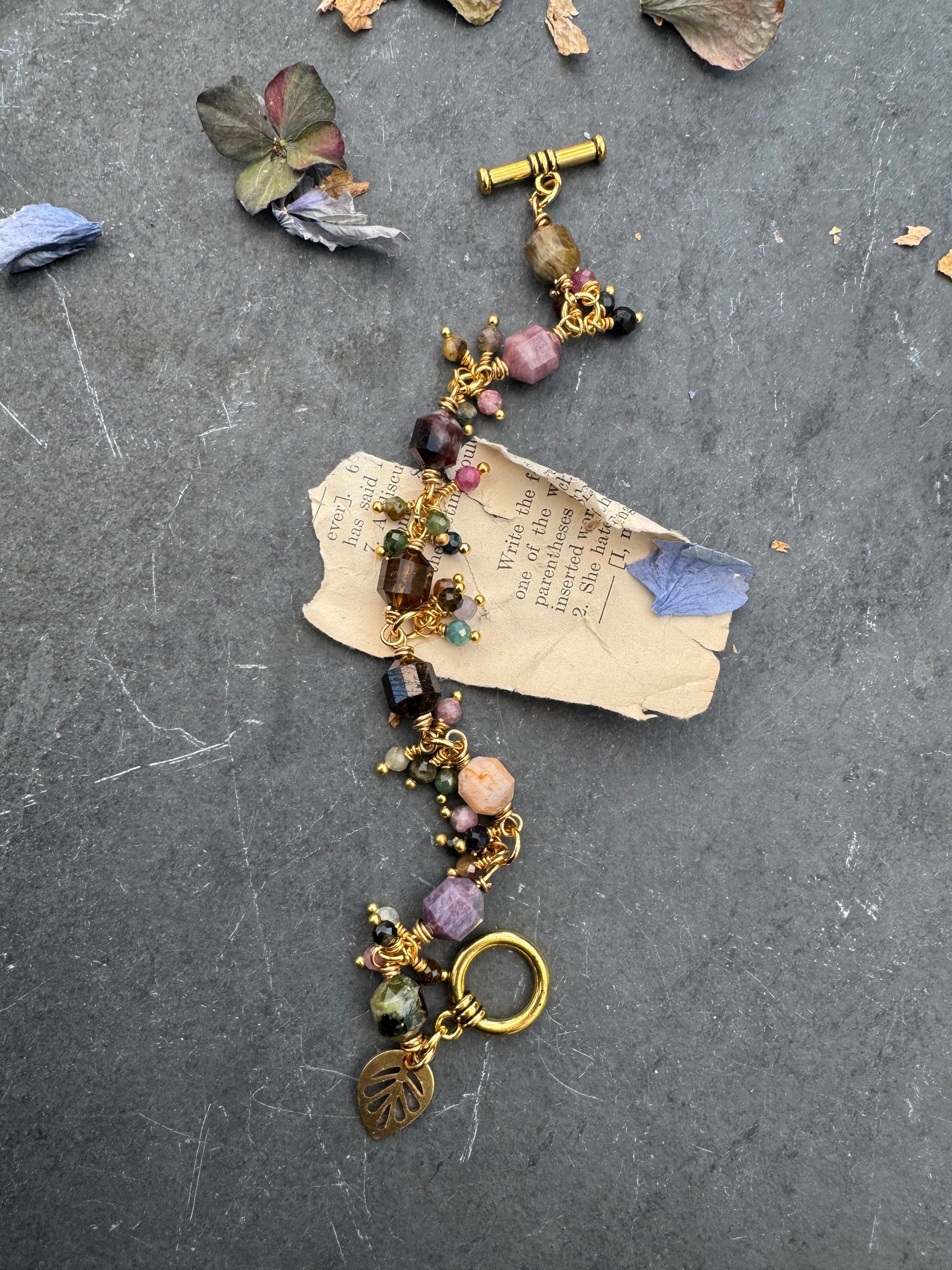 Watermelon tourmaline stone, wire wrapped, gold metal bracelet.