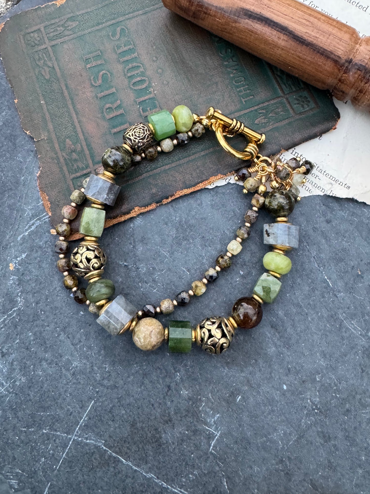 Green garnet, labradorite, jade, and gold metal, bracelet.