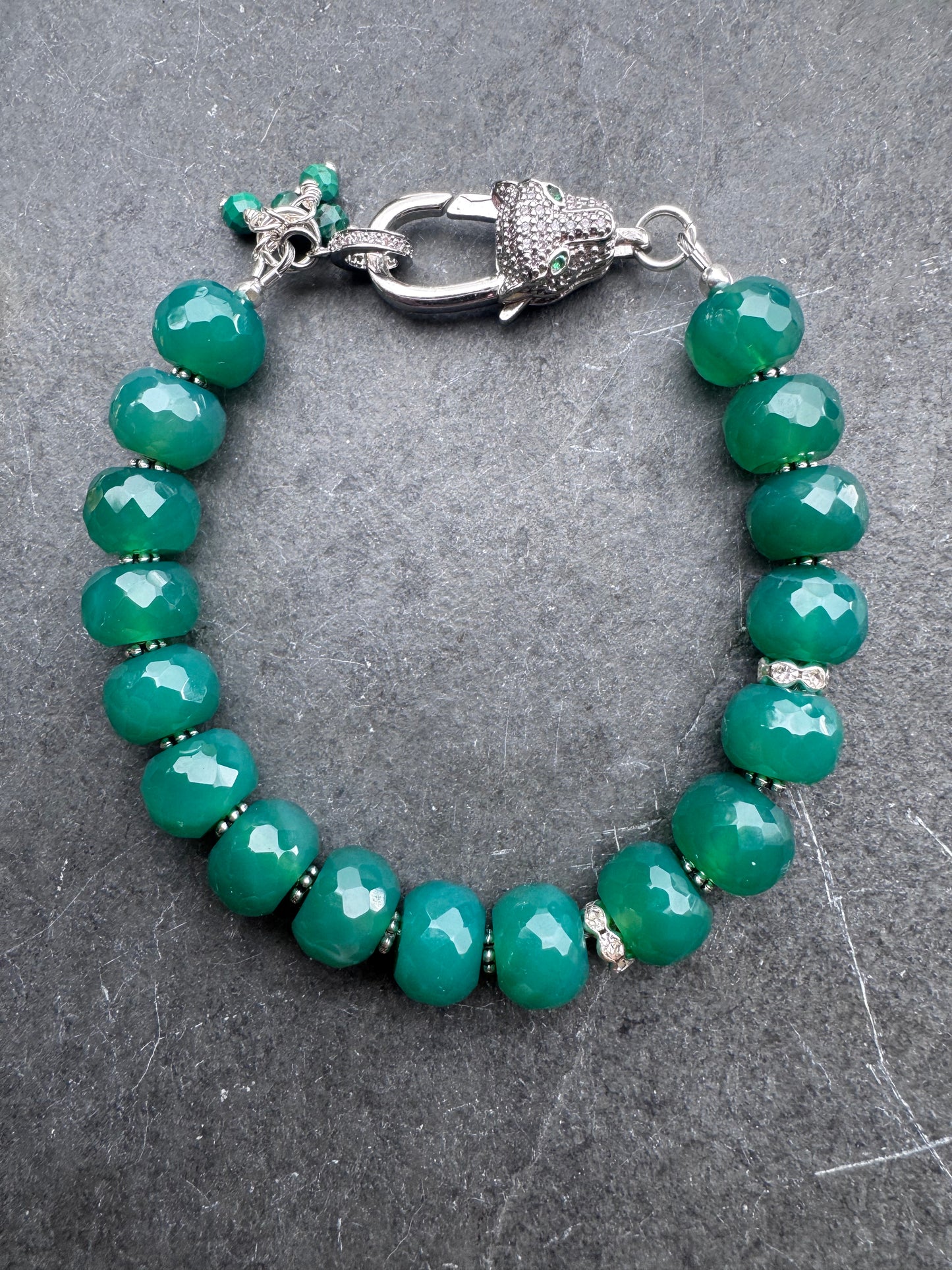 Green onyx faceted stone, jaguar silver rhinestone clasp.