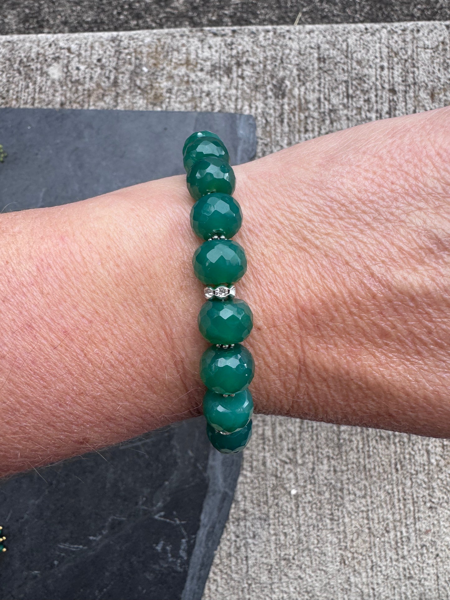 Green onyx faceted stone, jaguar silver rhinestone clasp.