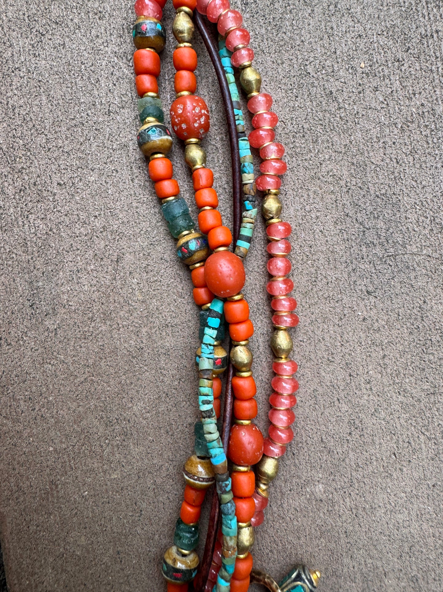 Turquoise, leather, African glass, wood, agate, brass metal bracelet.
