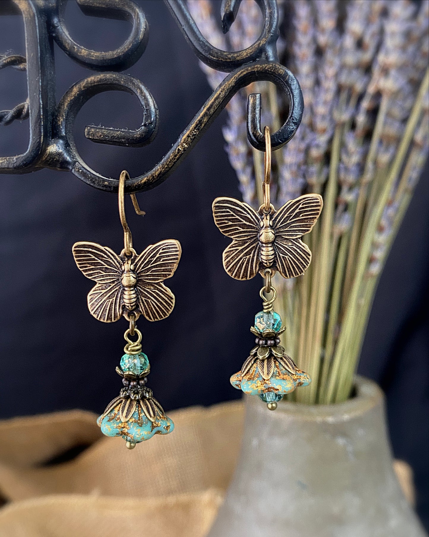 Brass butterfly charms, turquoise Czech glass, flower bead caps, bronze metal, earrings
