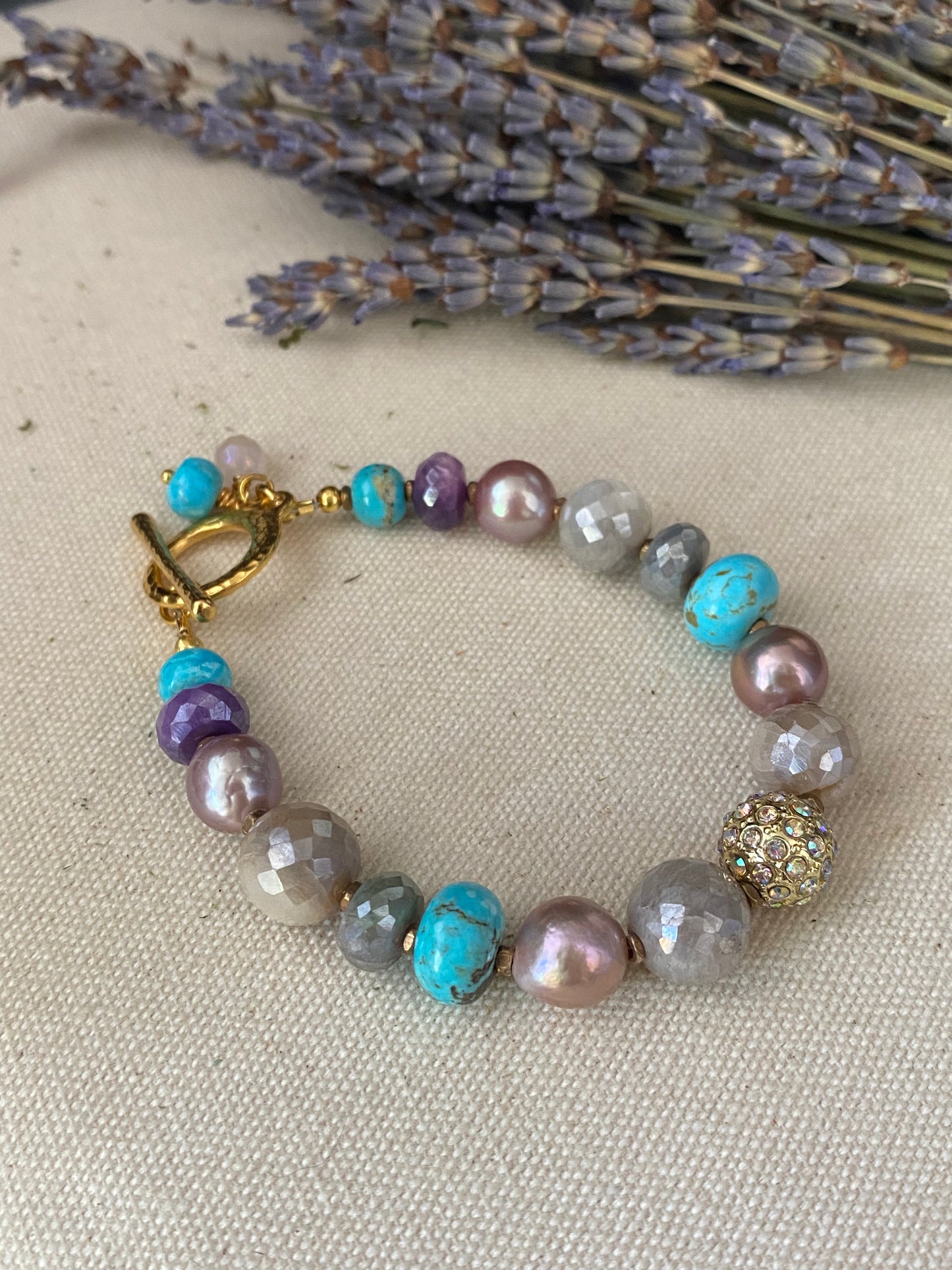 Pink pearls, blue turquoise stone, mystic moonstone, gold metal, bracelet.