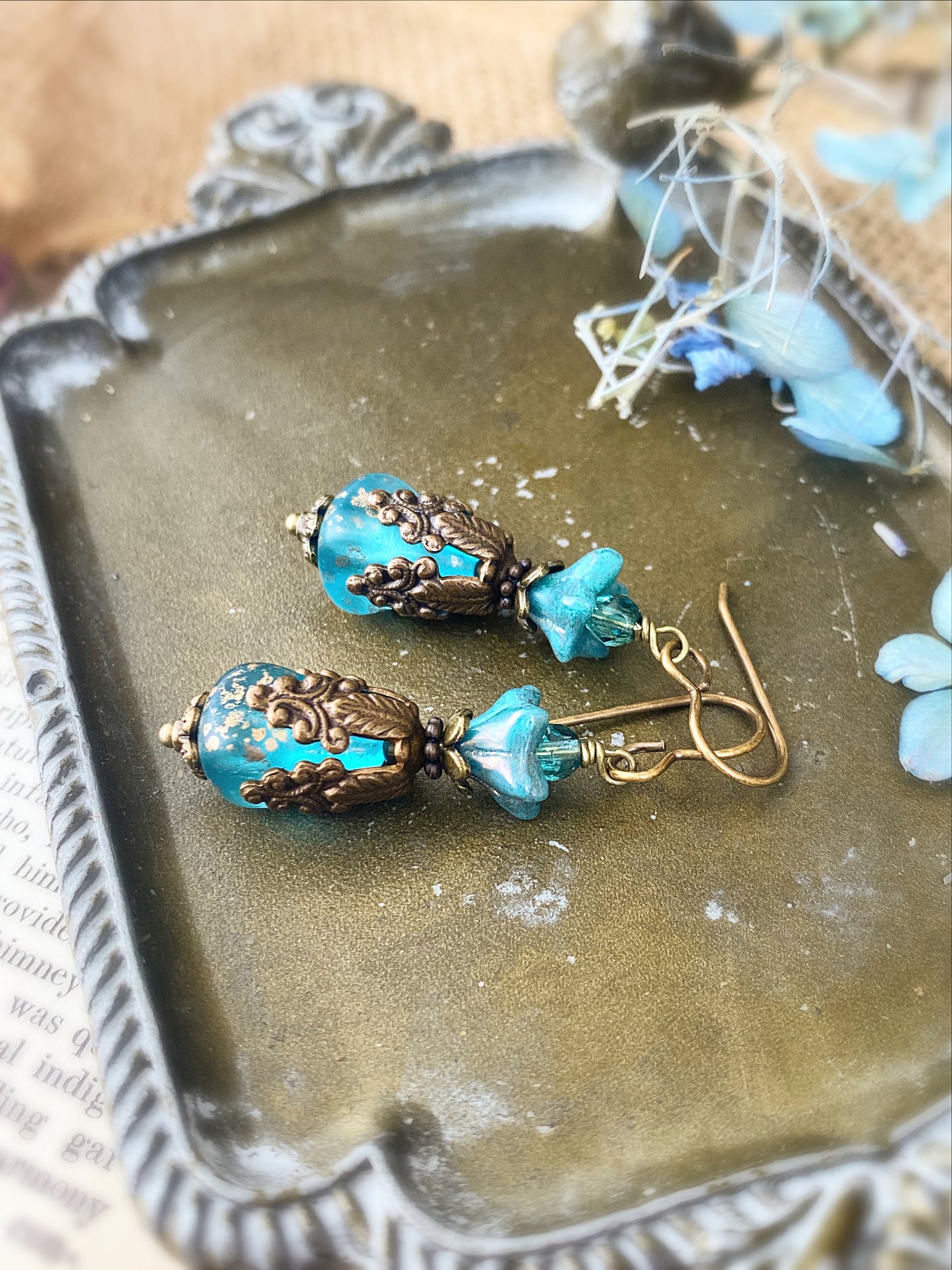 Blue Czech glass, chocolate bronze filigree flower bead caps, and bronze metal earrings.