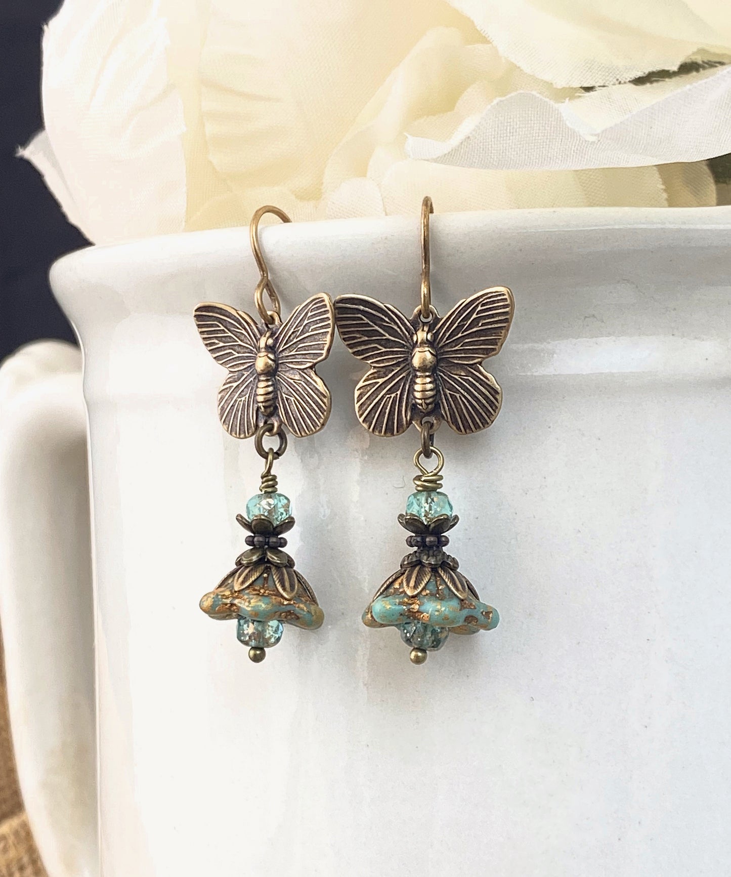 Brass butterfly charms, turquoise Czech glass, flower bead caps, bronze metal, earrings