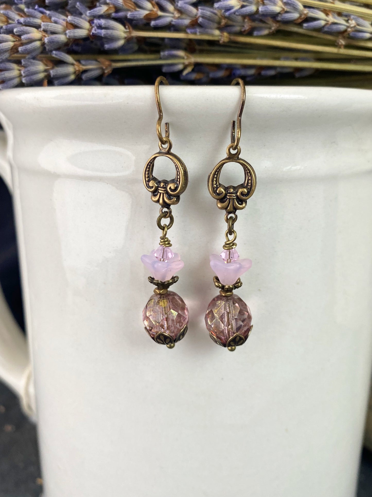 Pink Czech glass, bronze flower bead caps, and bronze metal earrings.