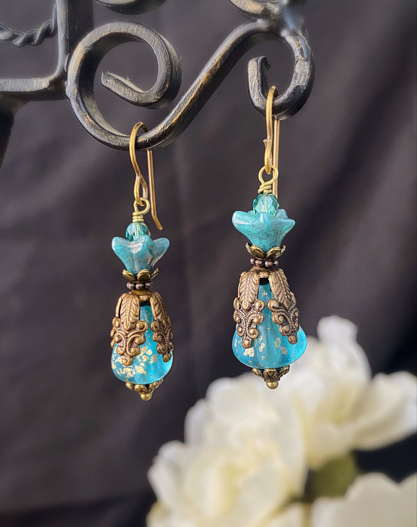 Blue Czech glass, chocolate bronze filigree flower bead caps, and bronze metal earrings.