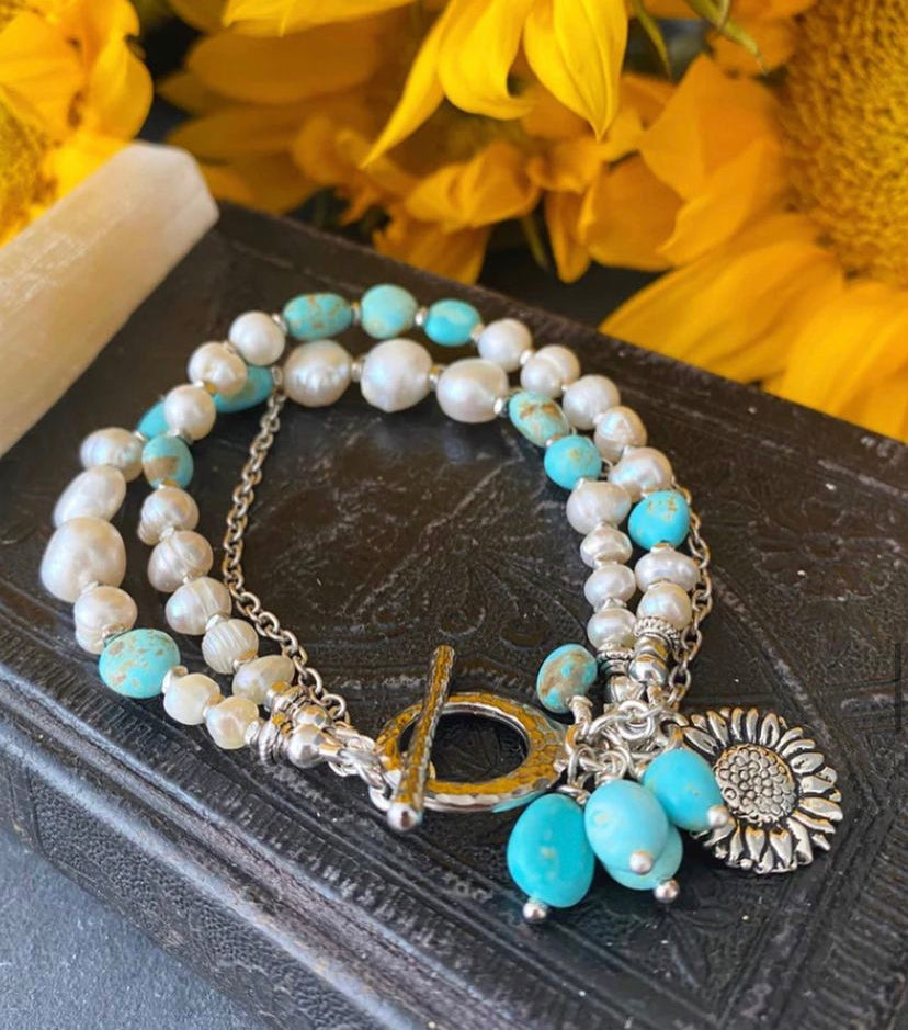 Turquoise stone, pearl, multi strands and silver metal bracelet.