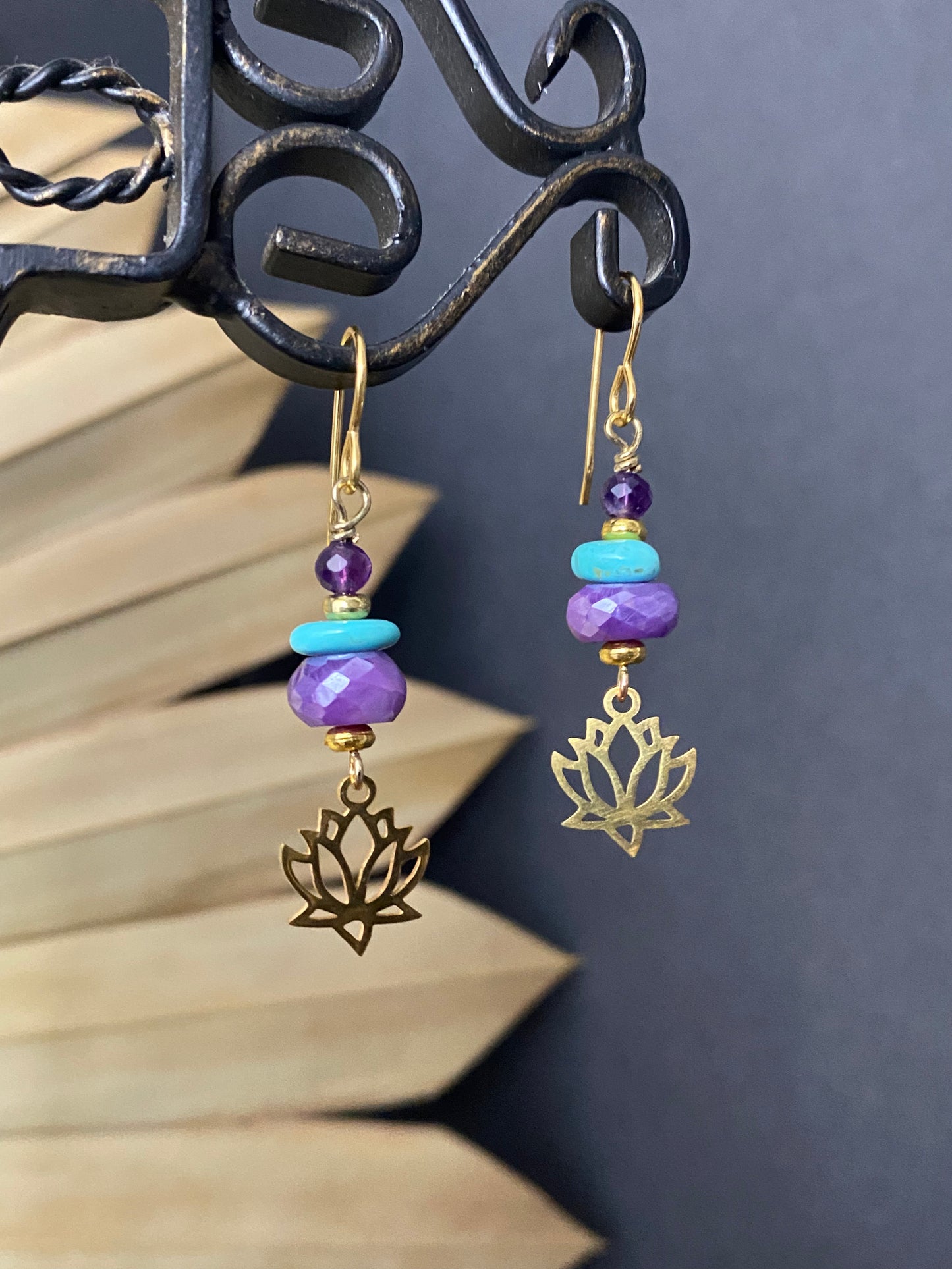 Turquoise, amethyst, lotus flower charms and gold metal earrings.
